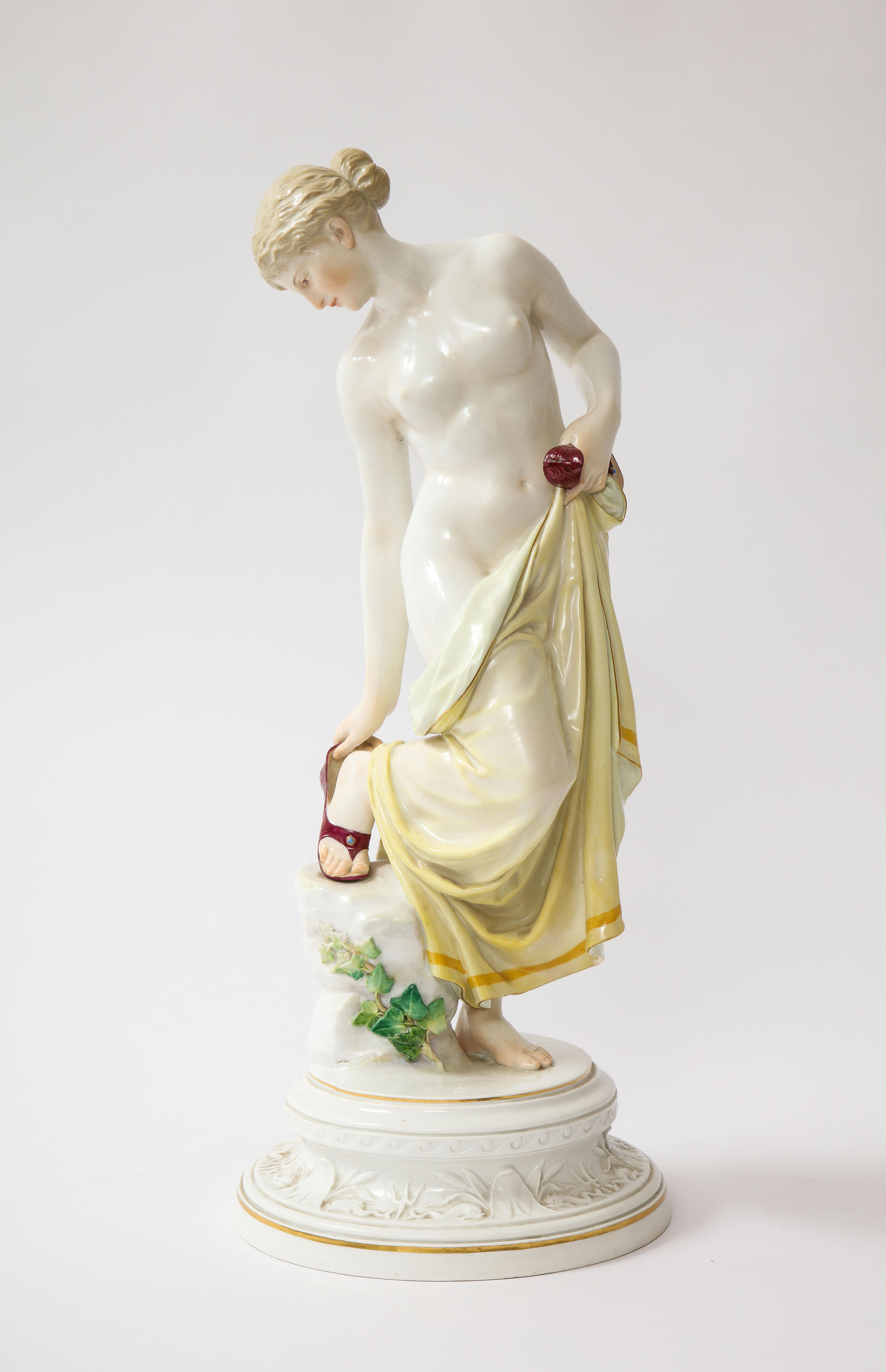 A 19th C. Meissen Porcelain Female Nude Figurine After The Bath, M 193b, R. Ockelmann.  This exquisite porcelain sculpture was skillfully created by the talented artist R. Ockelmann.  The figurine portrays a partially nude woman, her visage
