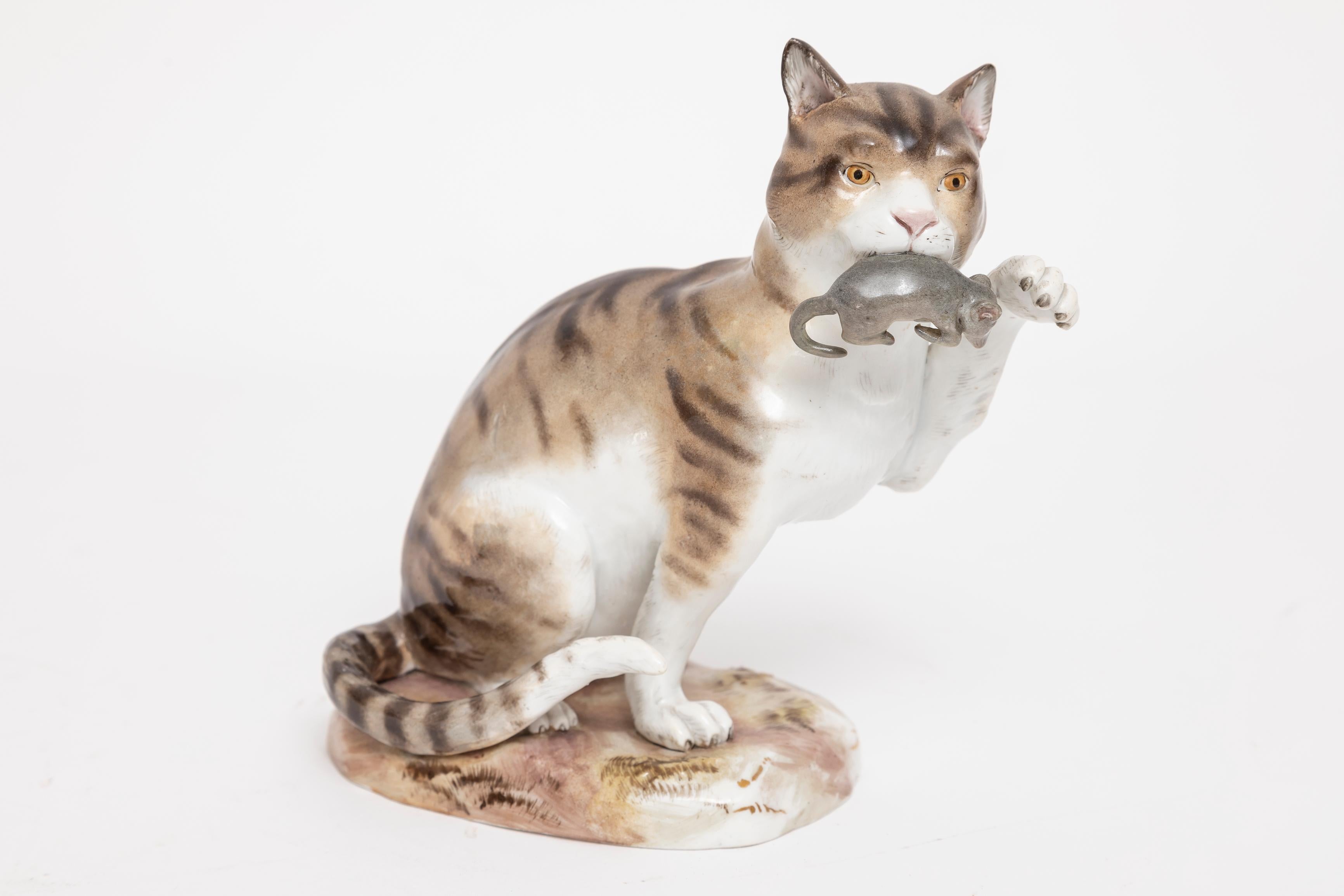A Marvelous 19th Century Meissen Porcelain Figurine Depicting a Cat with Captured Mouse. 
 Standing at an impressive 7 inches tall, this adorable handcrafted, hand-painted Meissen Porcelain striped cat stands as a testament to Meissen's exquisite
