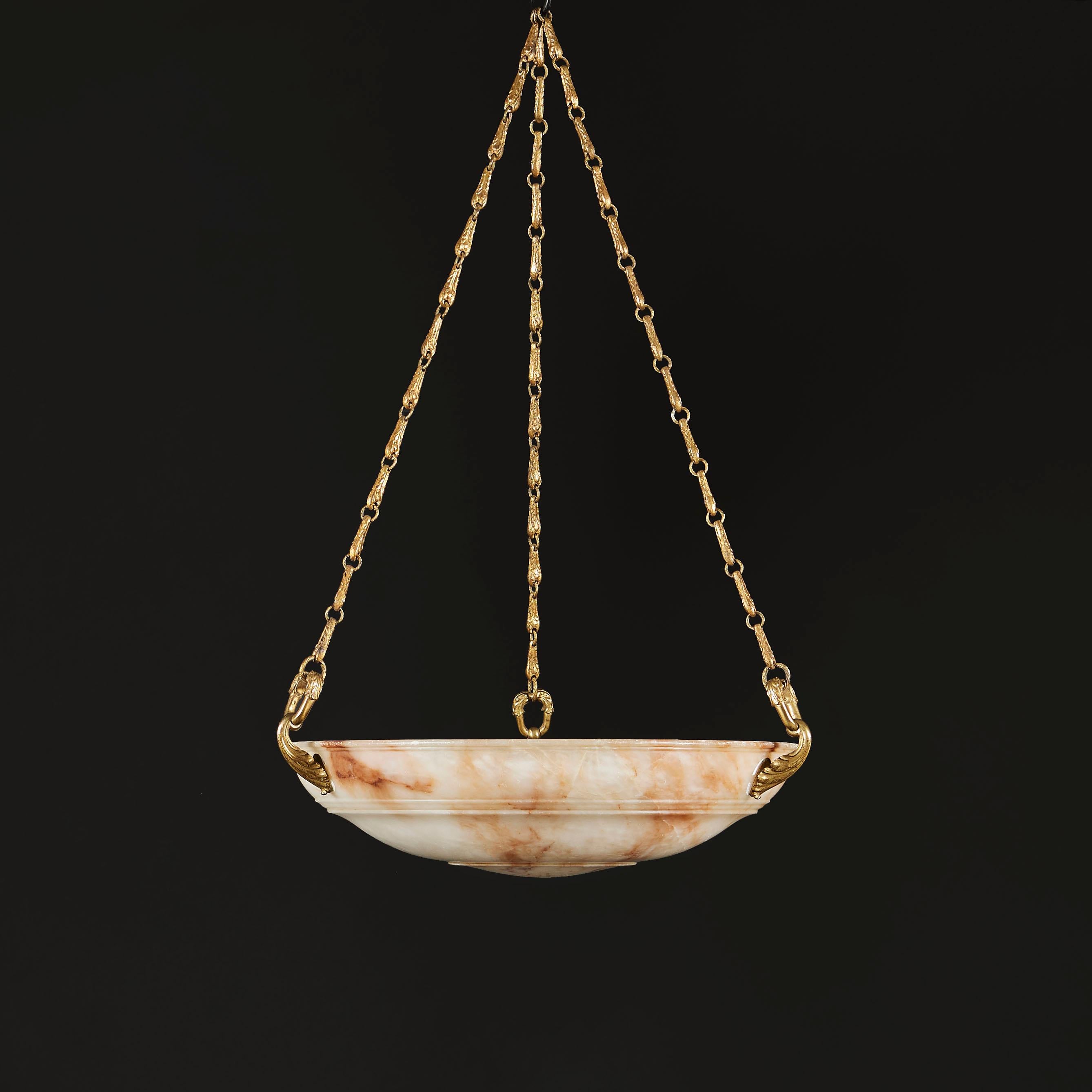 A mid nineteenth century alabaster dish light with engraved concentric circles suspended with finely chased ormolu chain.

Currently wired for the UK.