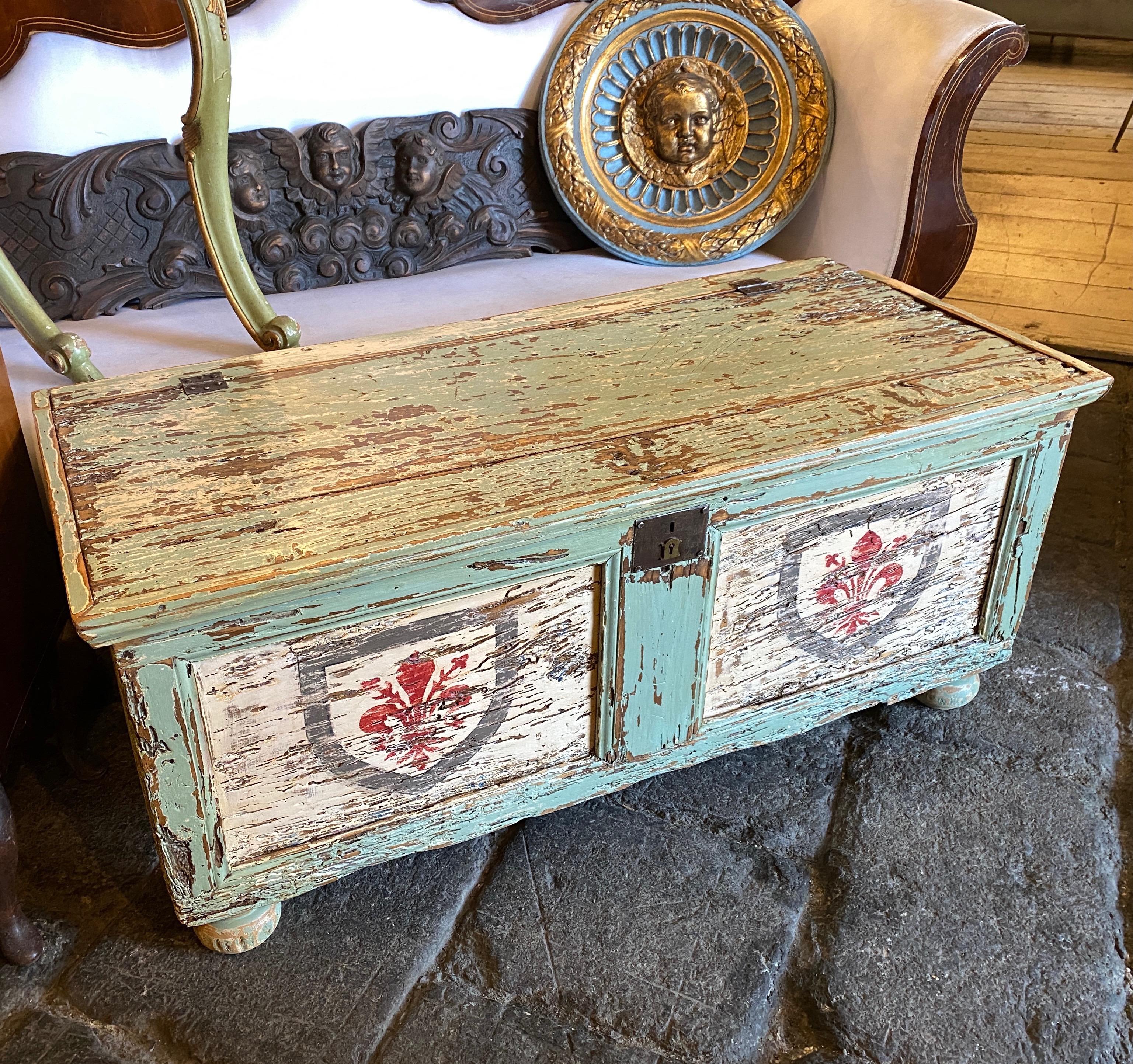 A Light green lacquered wood chest made in Tuscany in the second half of 19th century. Noble coat of arms with red lily are on the front and in the sides. Original conditions