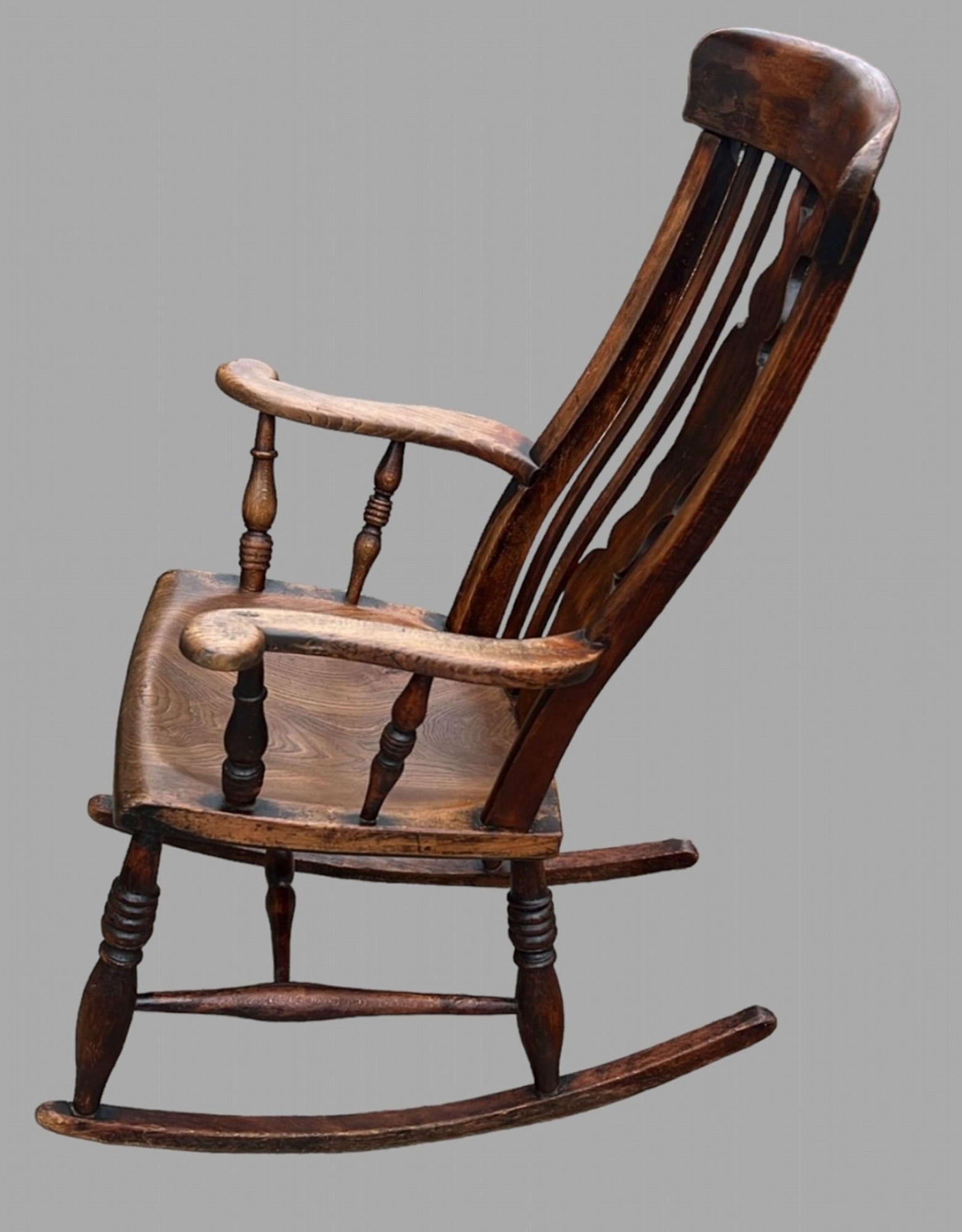 A 19thc Ash and Elm Splat Back Windsor Rocking Armchair. Most stylles of this chair were made arounds woods surrounding Wycombe this particular style has roots in Dorset and Somerset and West Country. A very comfortable fire side chair as it is