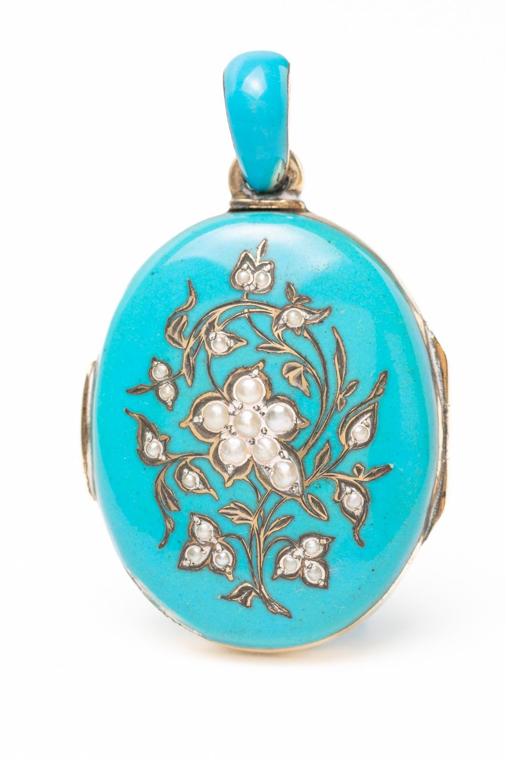 A 19th century Austrian-Hungarian silver and blue enamel oval locket with forget me not motif. The front of the piece depicting beautiful floral composition made with a 'forget me not ' flower in the centre set with natural seed pearls and a silver