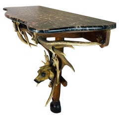 A  19th century  balck forest antlers console with marble top.