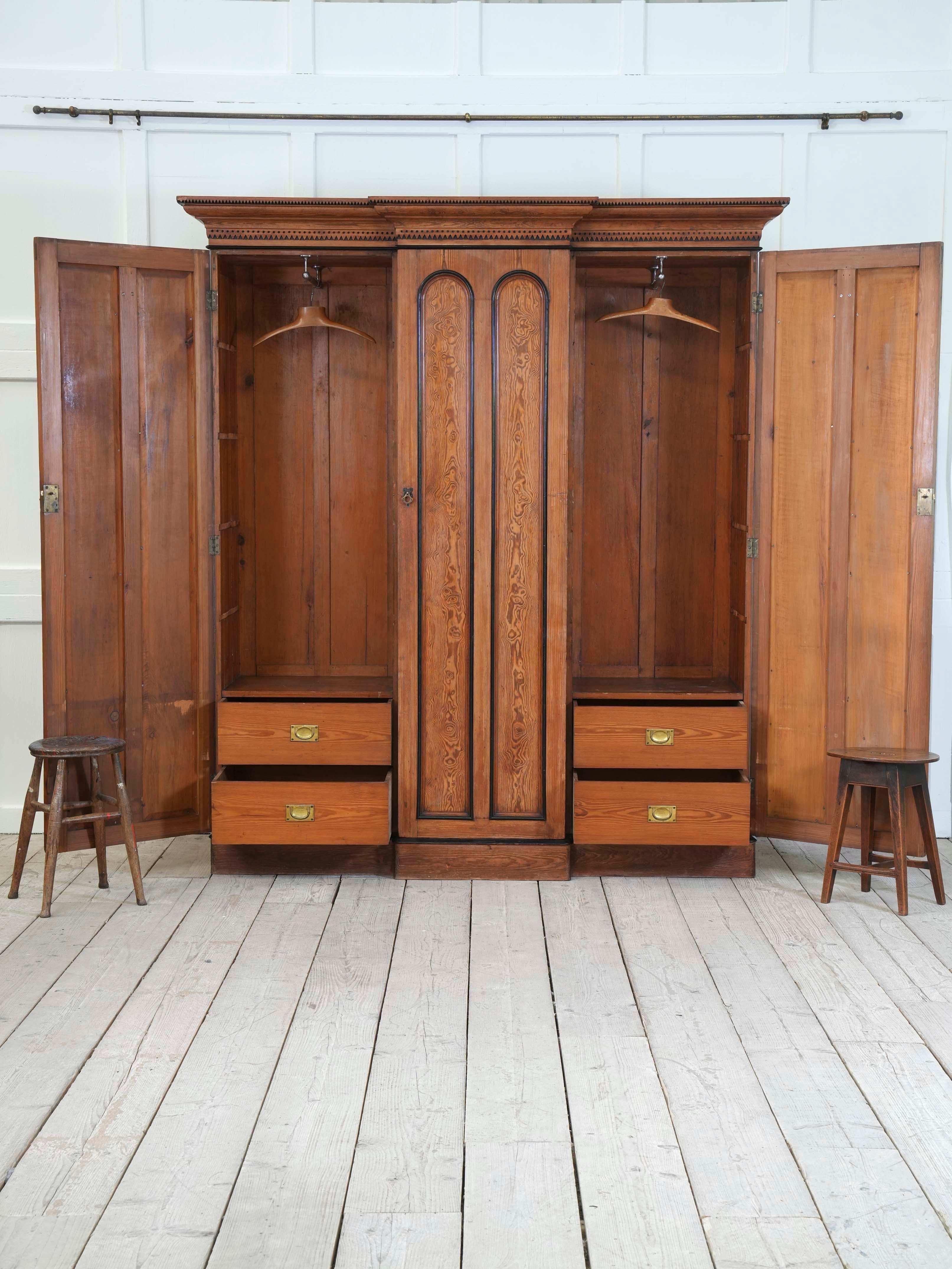 Well figured pine with ebonized detail to the cornice, door fronts and plinth, original brass door furnishings, hanging space above drawers and sliding linen trays.
English, circa 1870.
H: 228 W: 184 D: 68 CM
H: 89.7 W: 72.4 D: 26.7 INCHES.