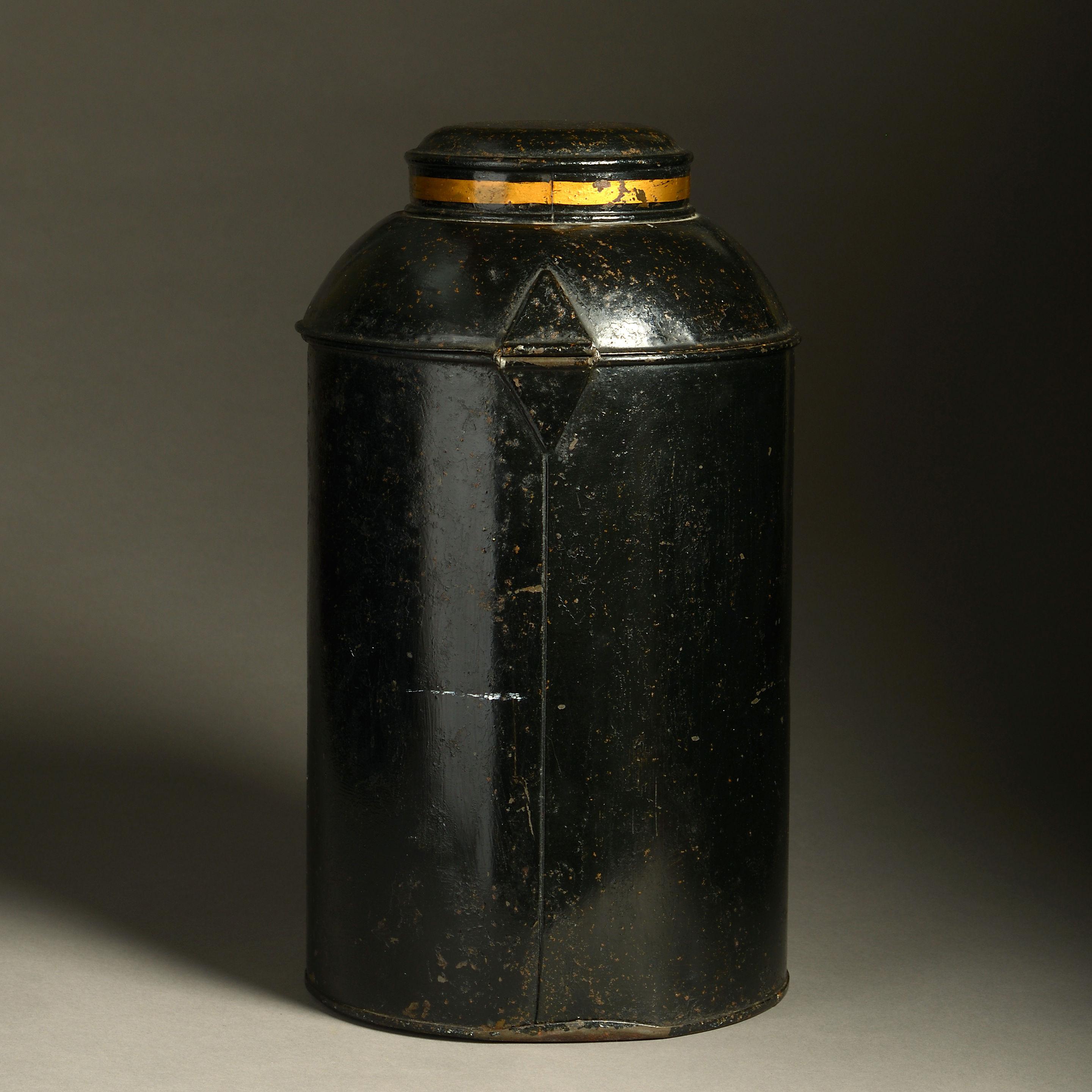A late 19th century black painted tole tea canister, having a domed hinged lid upon a cylindrical body and decorated with Chinese characters upon a gilded cartouche.
