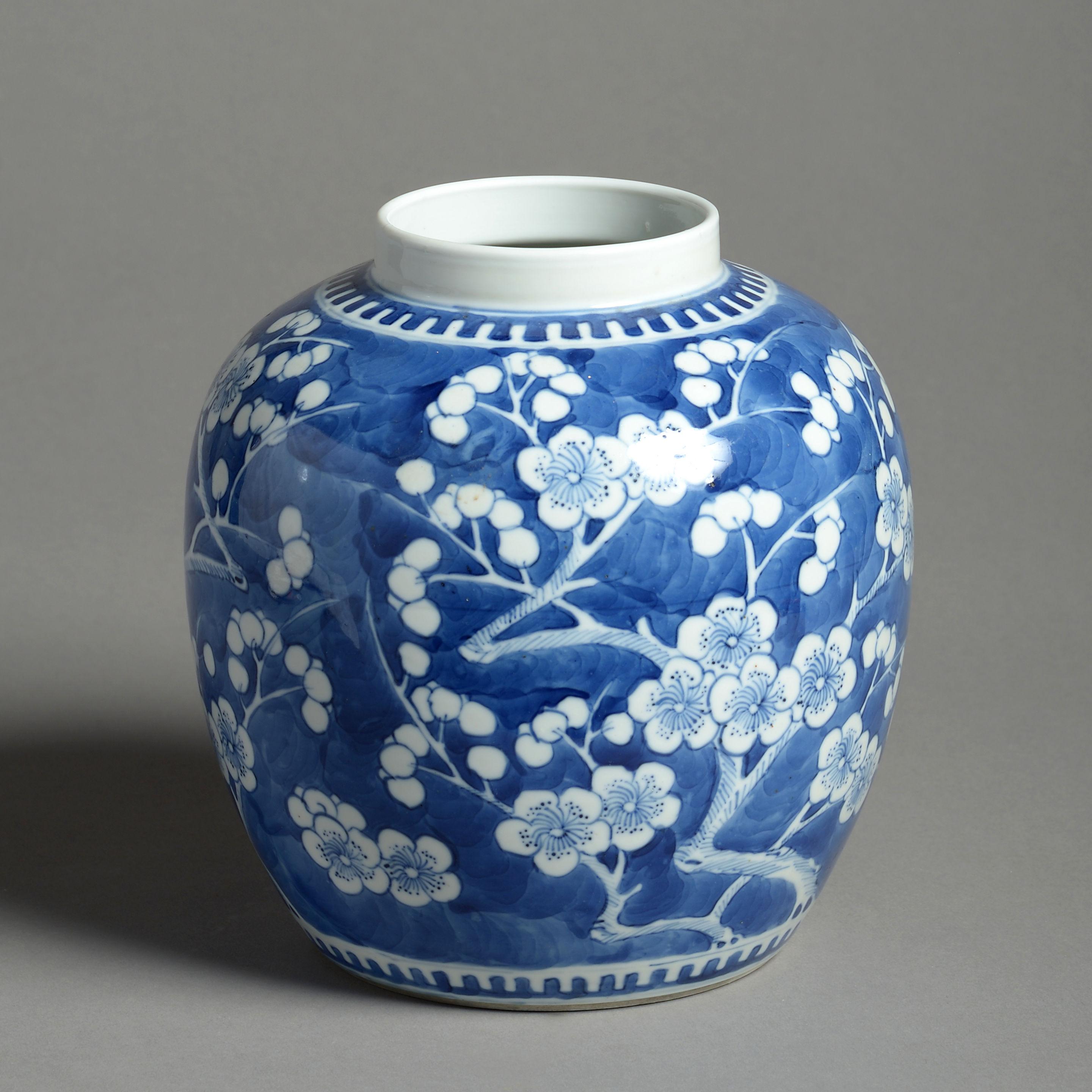 A 19th century porcelain jar of bulbous form, decorated throughout with white prunus blossoms upon a blue ground. 

Having character marks to the underside.