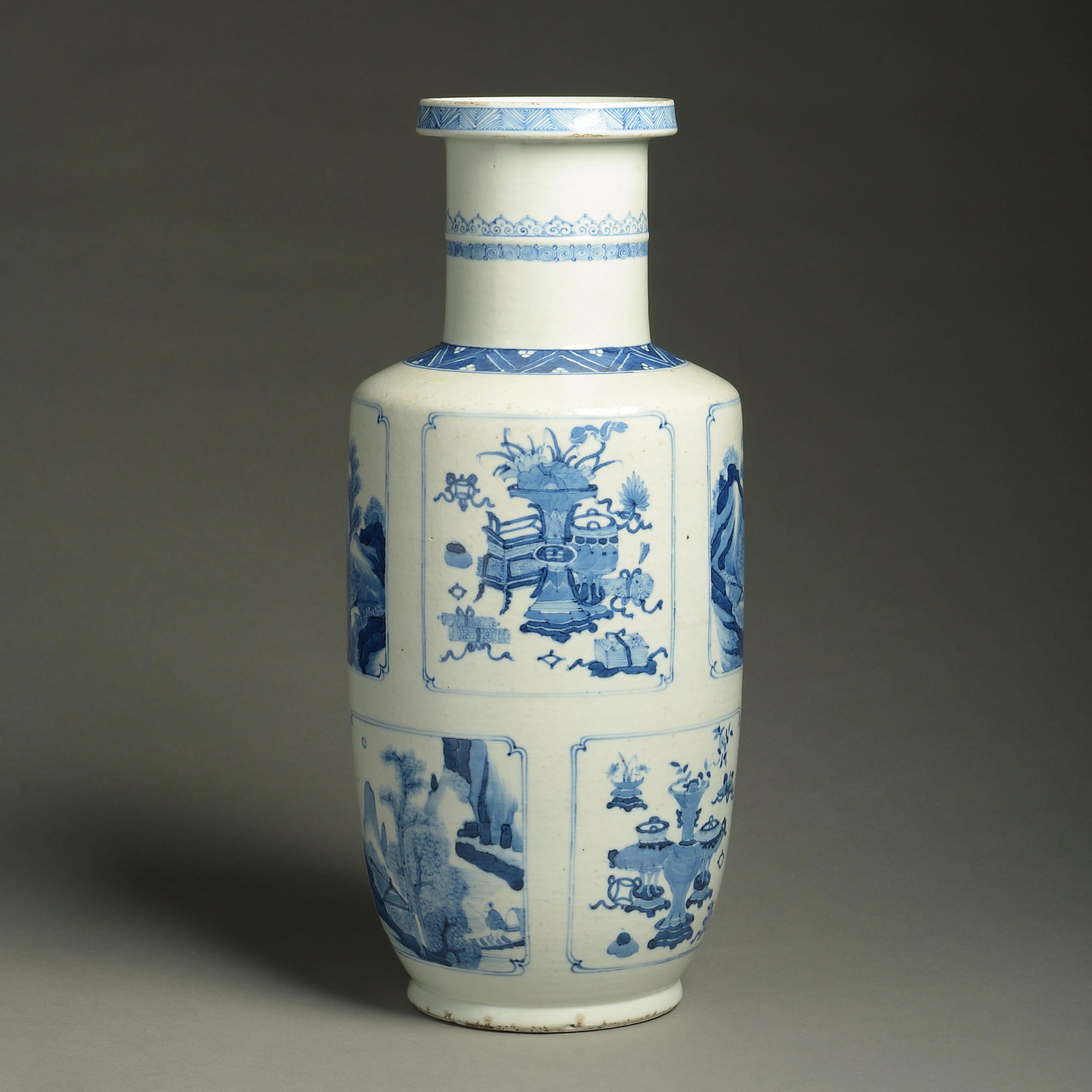 A 19th century blue and white porcelain rouleau vase, decorated throughout with panels depicting figurative scenes, landscapes and still life in the Kangxi manner. 

Late Qing dynasty.
  