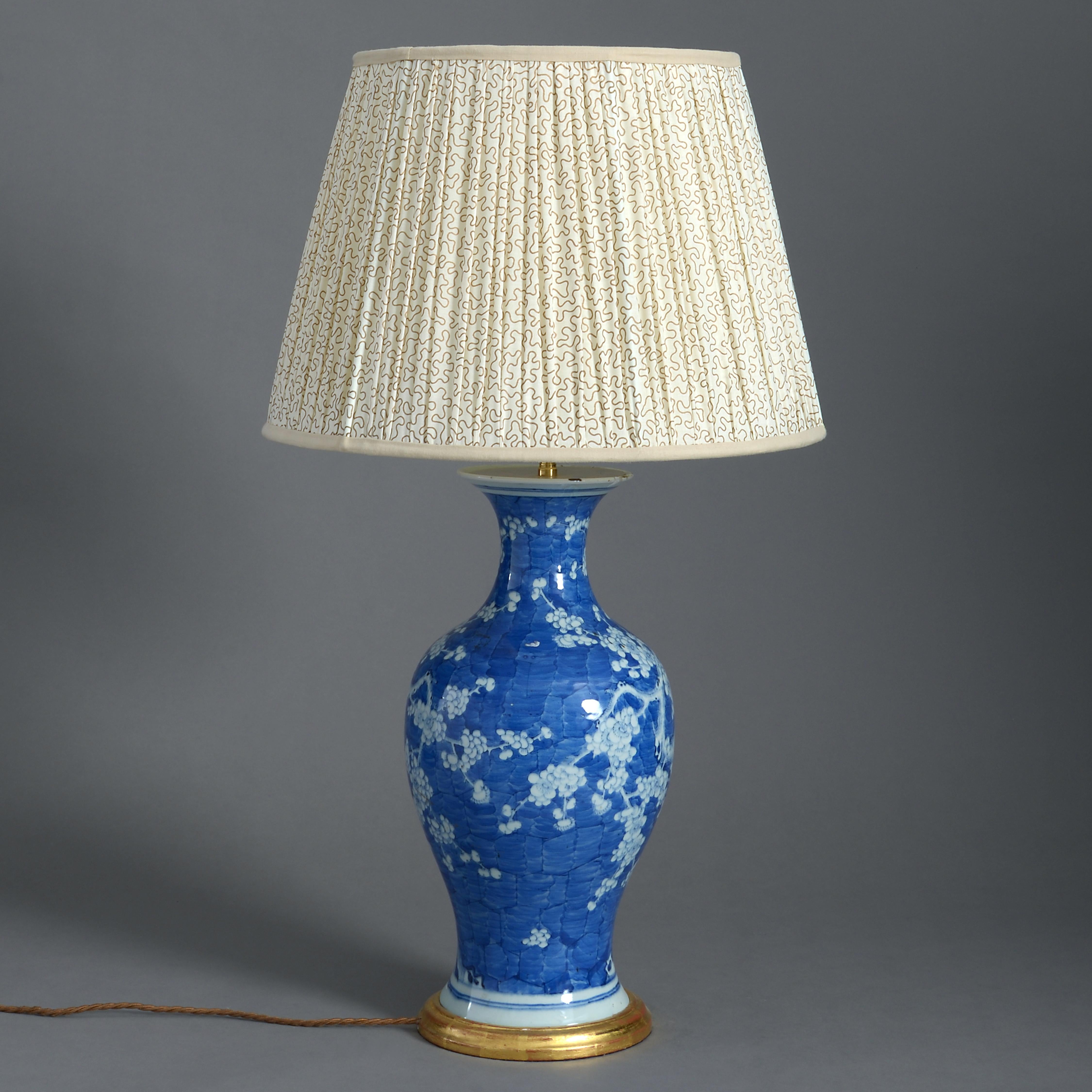 A 19th century blue and white glazed porcelain baluster vase, with prunus blossom decoration, now mounted as a lamp with turned water gilded base.

Dimensions refer to vase and base, excluding electrical components.