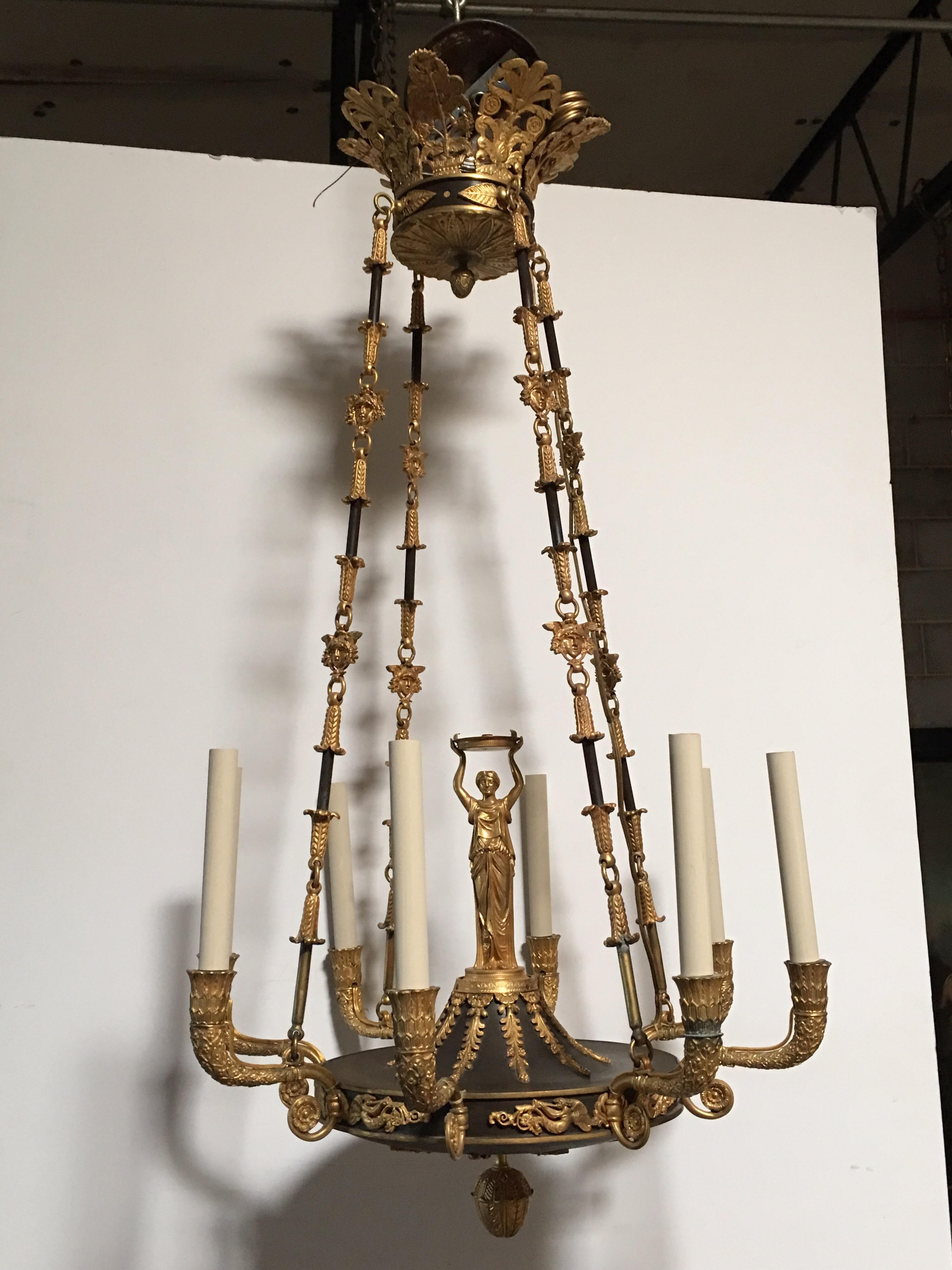 A French Empire style patinated and gilded bronze chandelier, late 19th century.