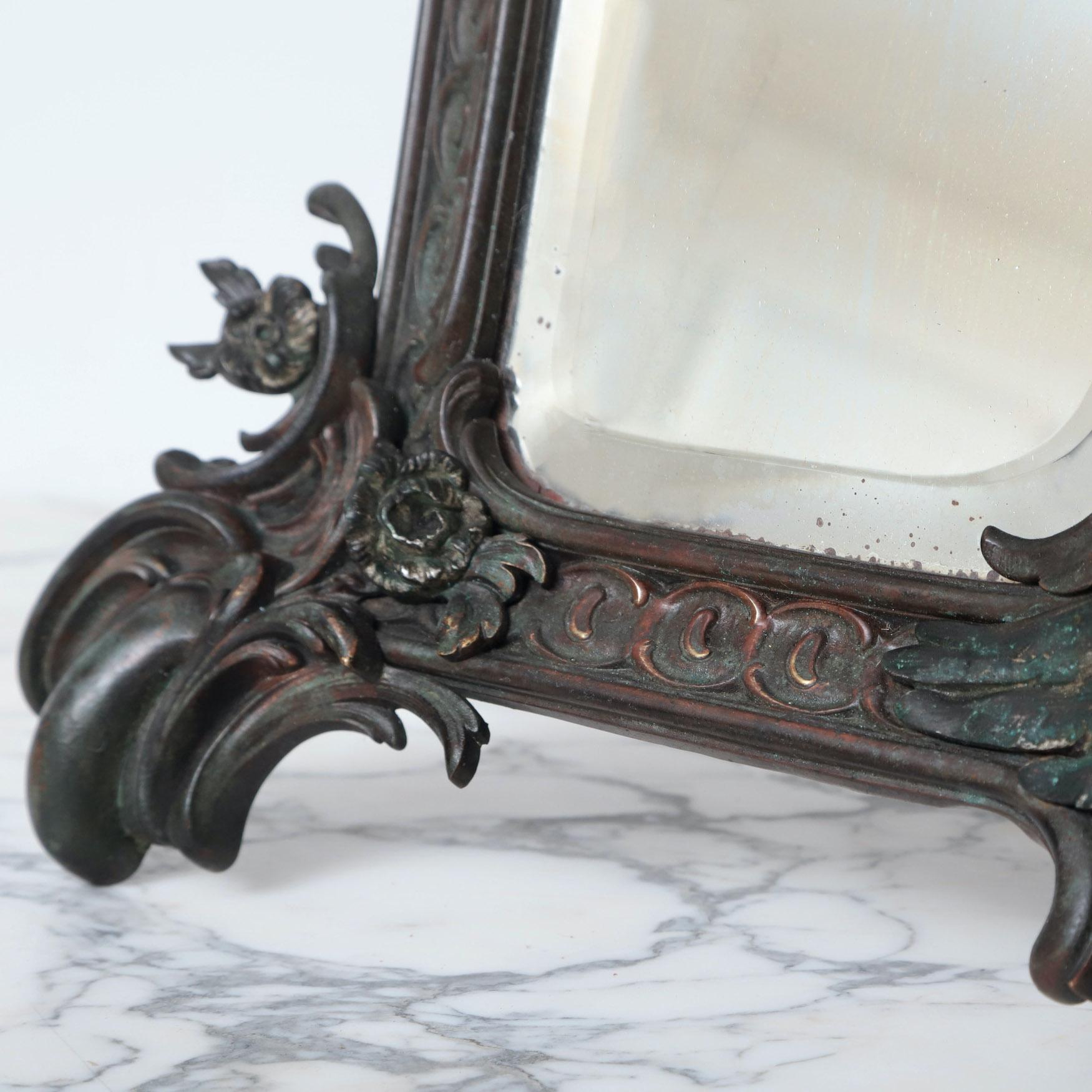 A 19th century bronze mirror.

France, probably Paris, circa 1860

Measures : Height: 84cm Width: 47cm Depth: (extended) 54cm

” An unusual 19th century bronze table mirror in the shape of harp ”

.