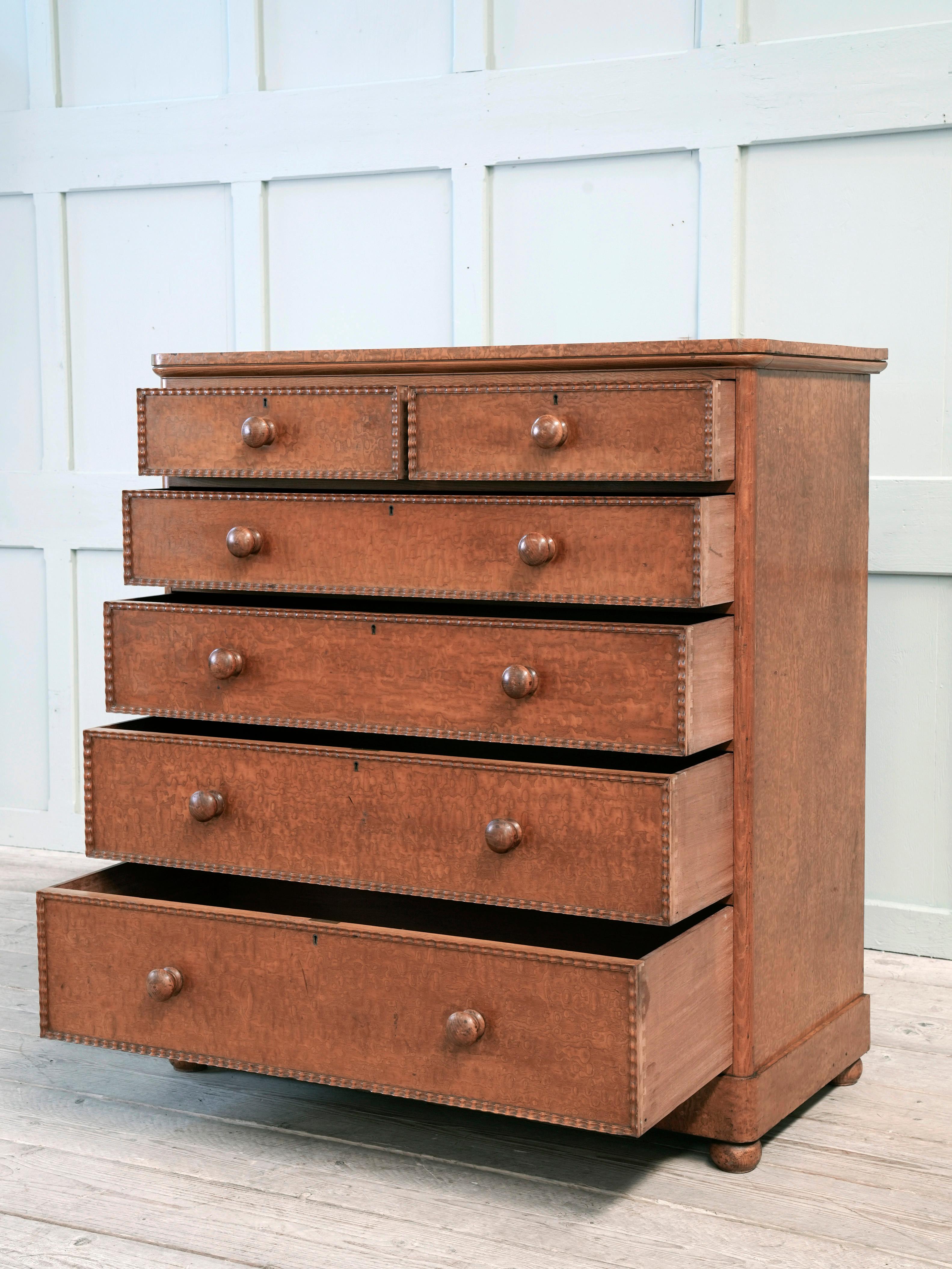 A large burr ash chest of drawers on the manner of Holland & Sons.

Four graduated long drawers above two short all with ripple carved borders, original handles and bun feet, drawer linings and back boards.

An outstanding example.

English