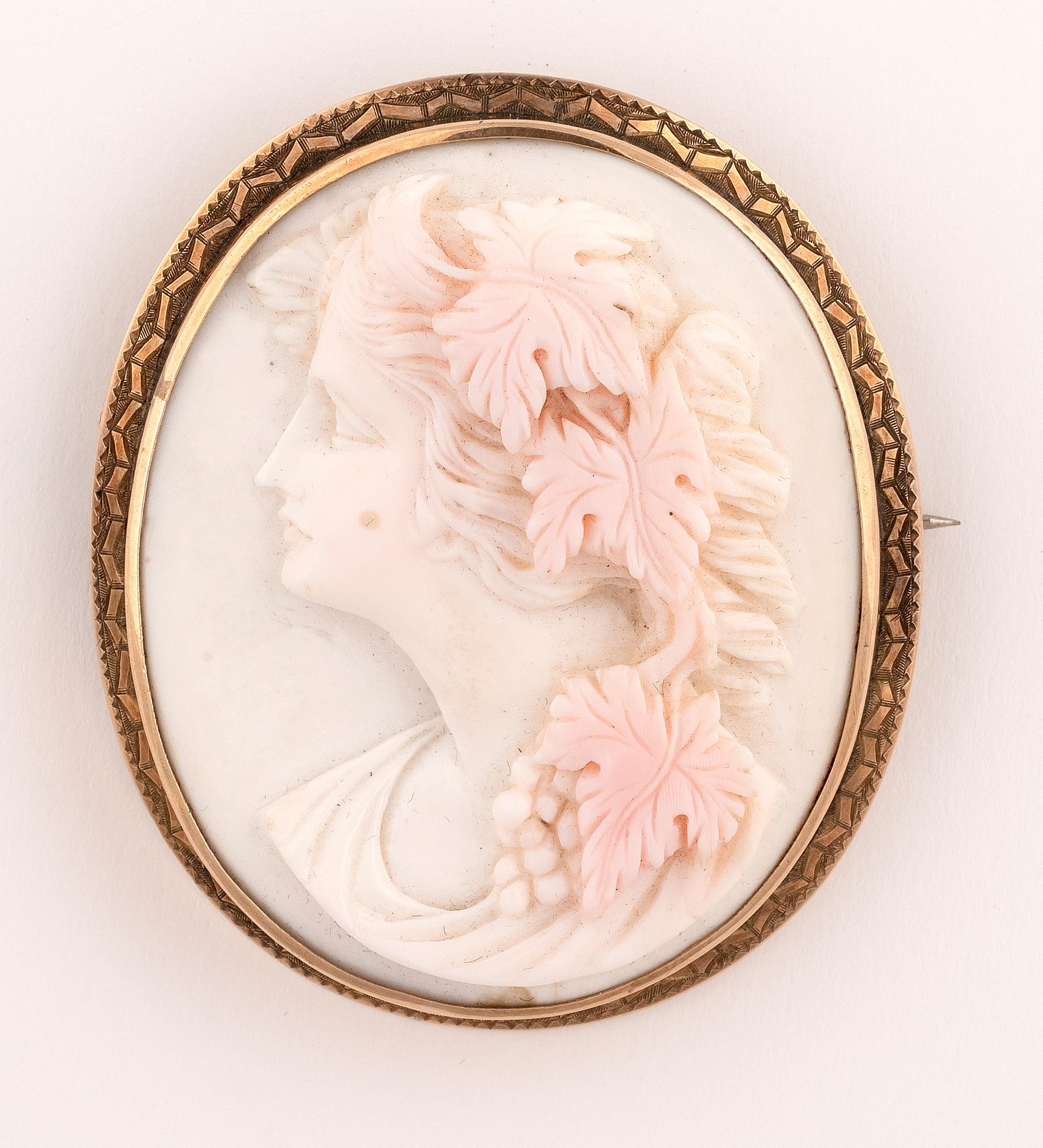 The coral carved to depict Bacchante within an gold frame, length 6.0cm.


