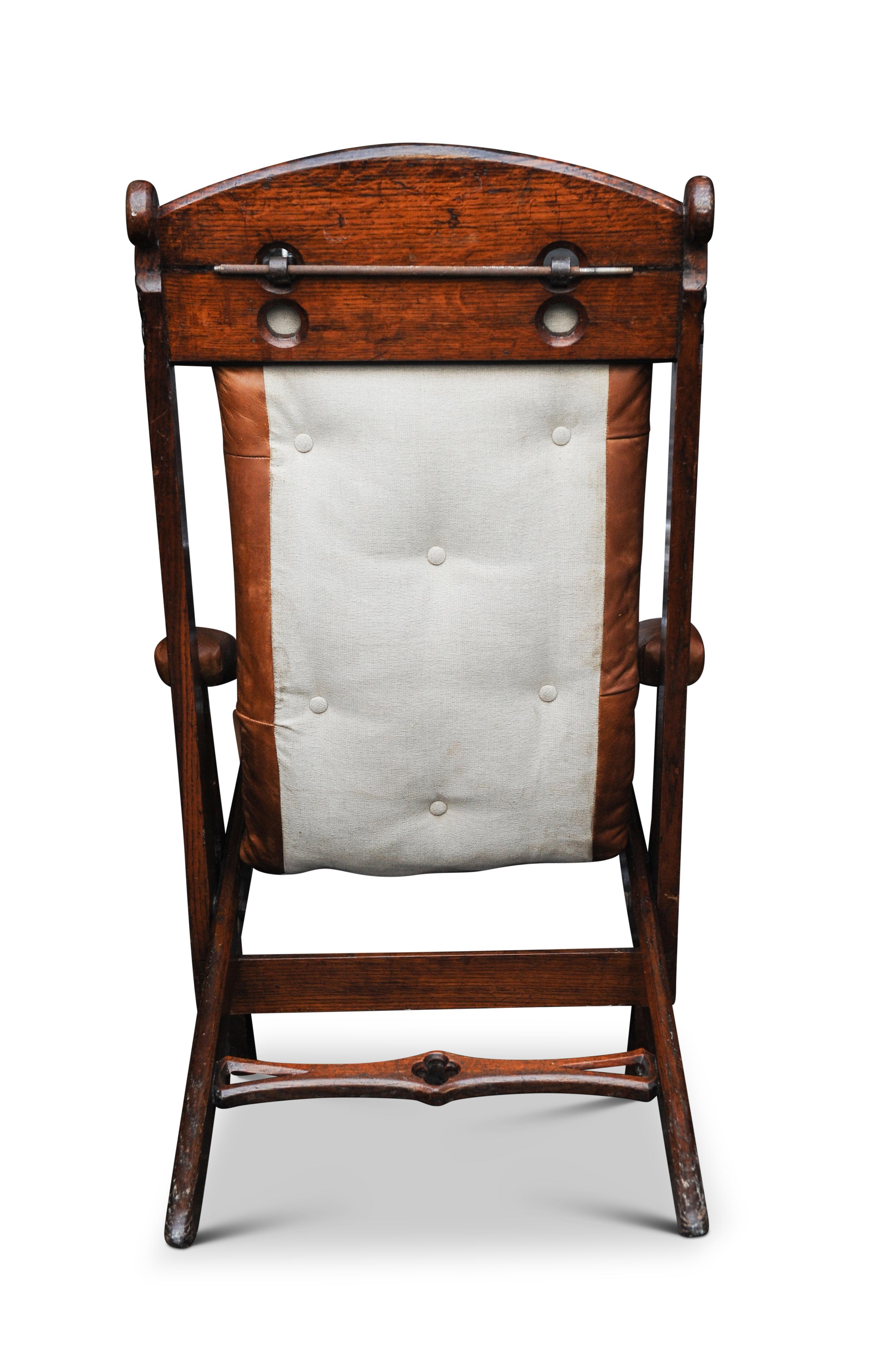 Hand-Crafted 19th Century Campaign Chair Herbert McNair Design Carved Oak and Tan Leather For Sale