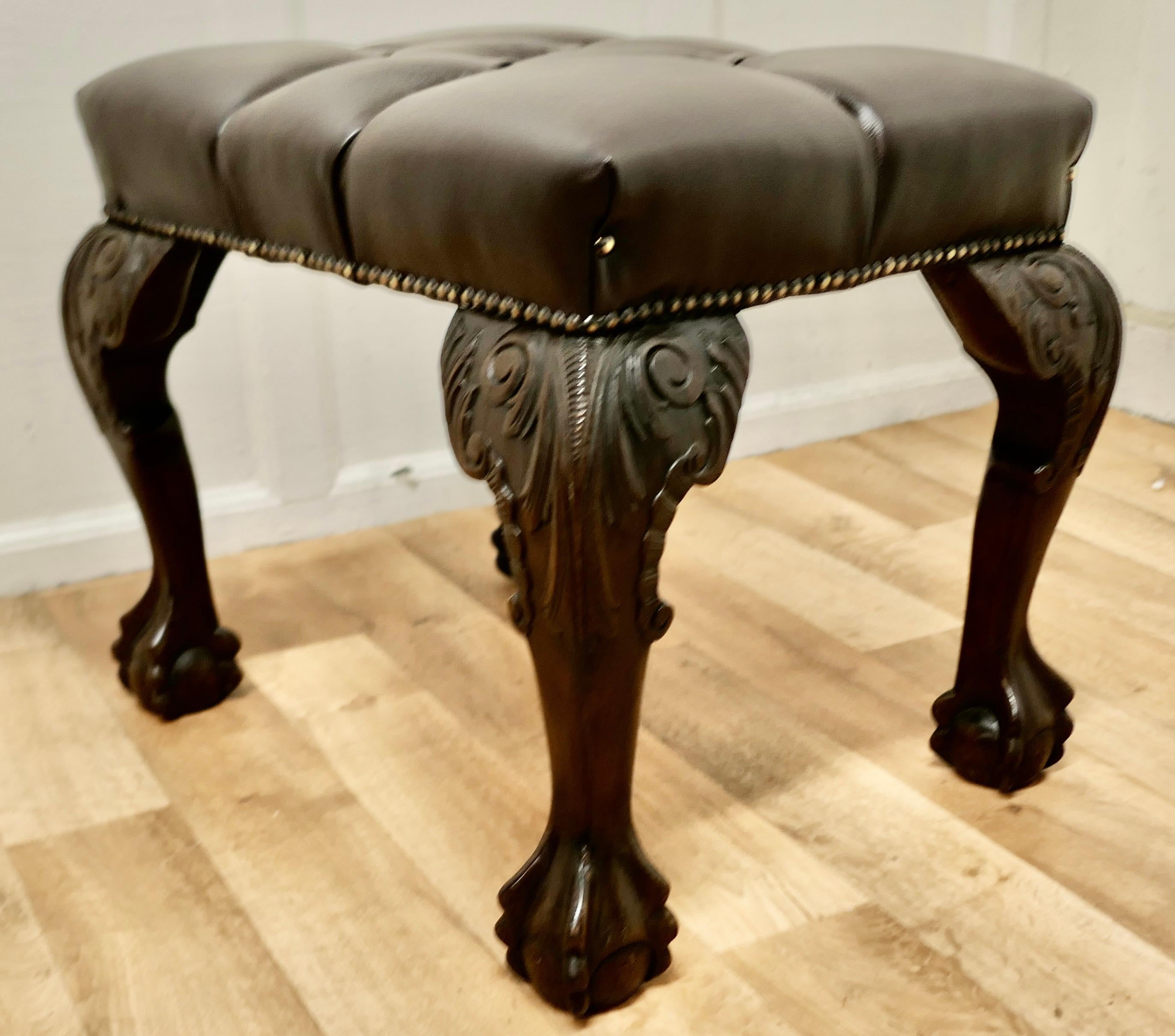 A 19th century carved walnut leather chesterfield library stool.

The stool is upholstered in deeply buttoned brown leather hide, it set on hefty ball and claw walnut cabriole legs which have deeply carved knees

An excellent piece of country