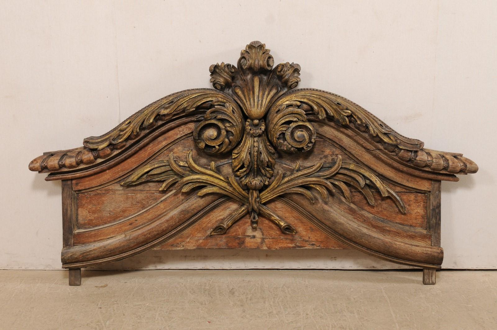 A large-sized American carved wood wall plaque from the 19th century. This antique wall decoration features a horizontally positioned plaque, which is approximately 6.5 feet in length, with a beautiful display of three dimensional carvings depicting