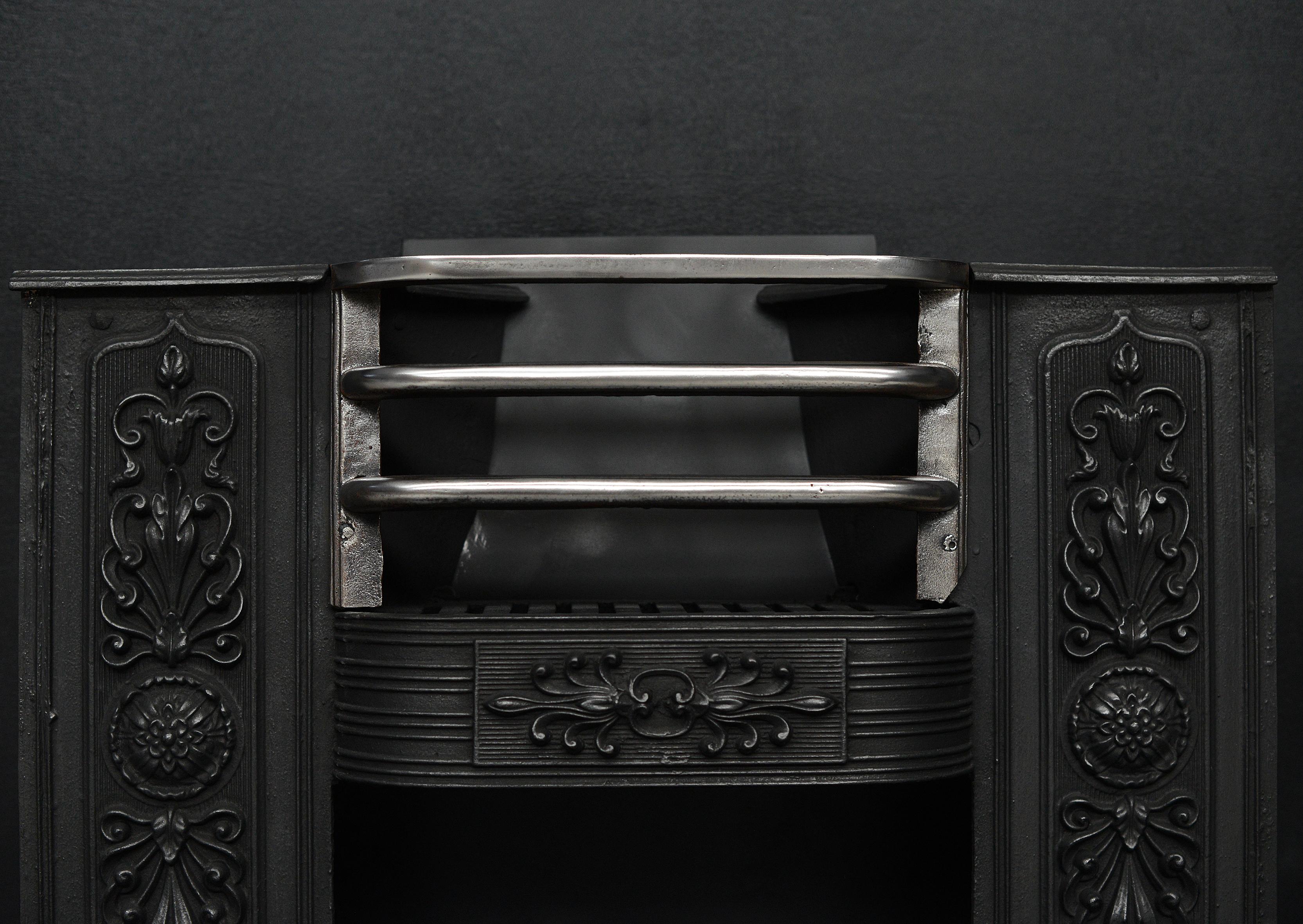 A 19th century cast iron hob grate, the reeded panels with anthemion and rosette detailing, shaped fret and polished steel front bars.

Width At Front:	720 mm      	28 ⅜