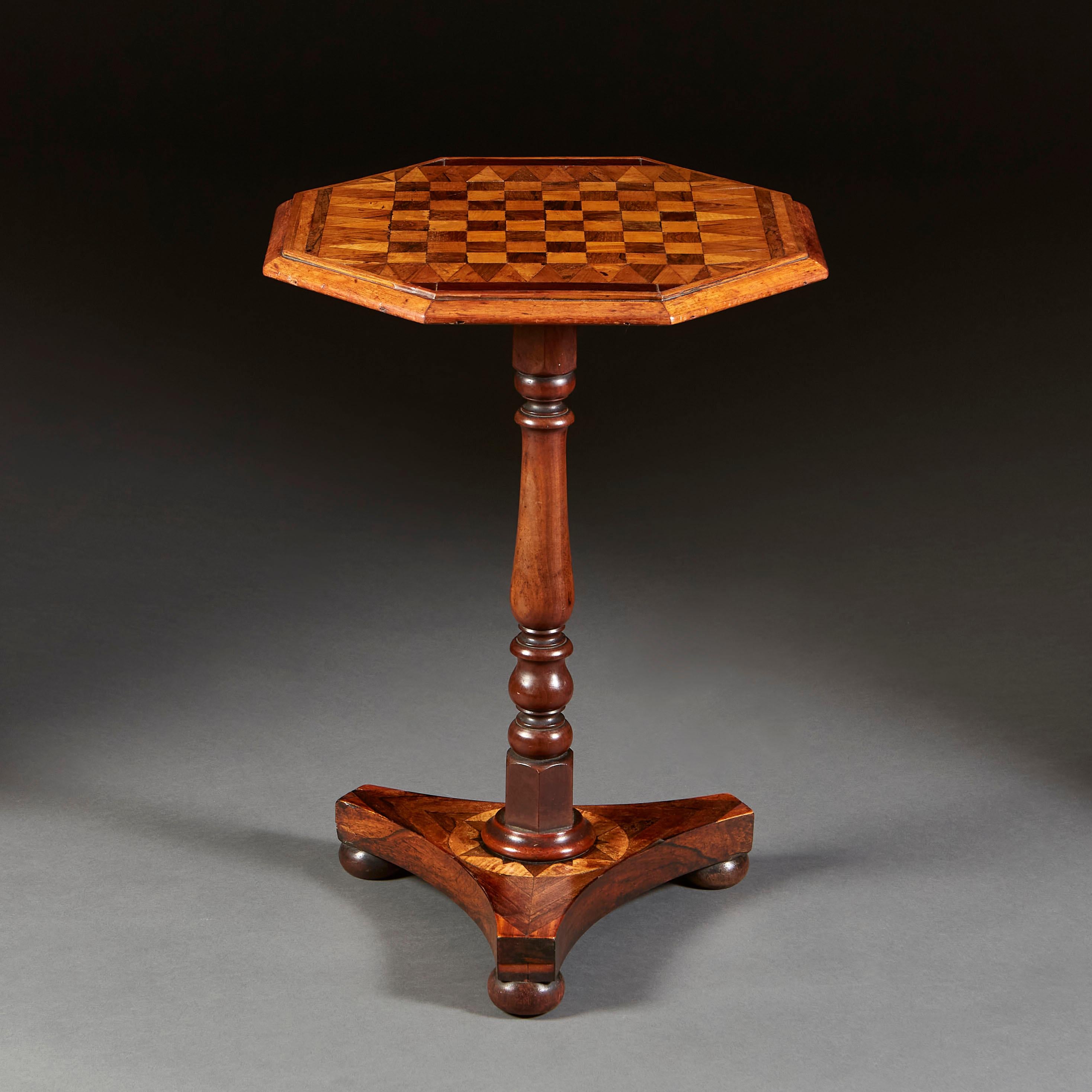 A mid nineteenth century occasional table with octagonal marquetry chess board top, the turned upright supported by a marquetry tripod base on bun feet.