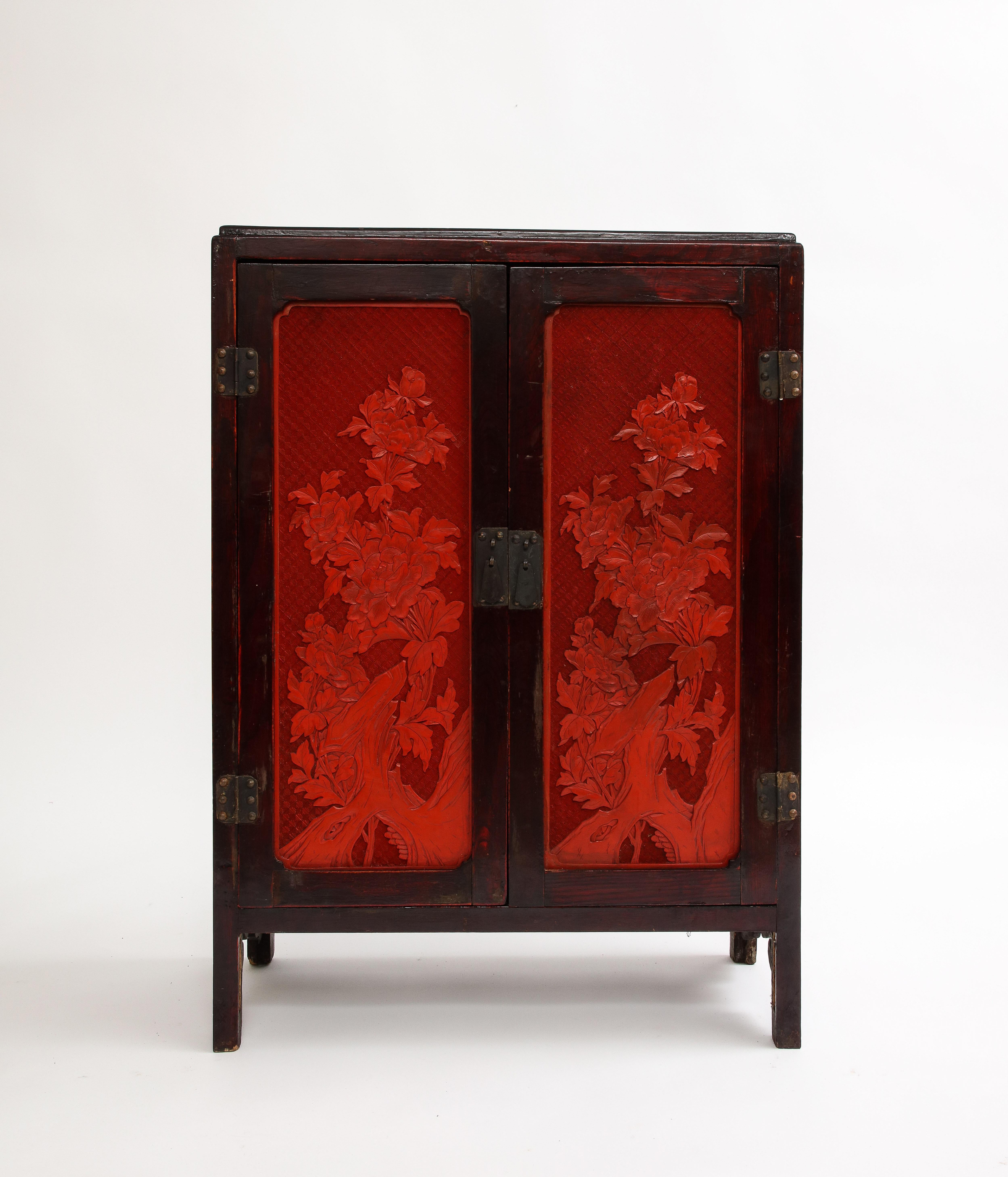 A 19th Century Chinese Cinnabar Panel Inlaid Hardwood Cabinet In Good Condition For Sale In New York, NY