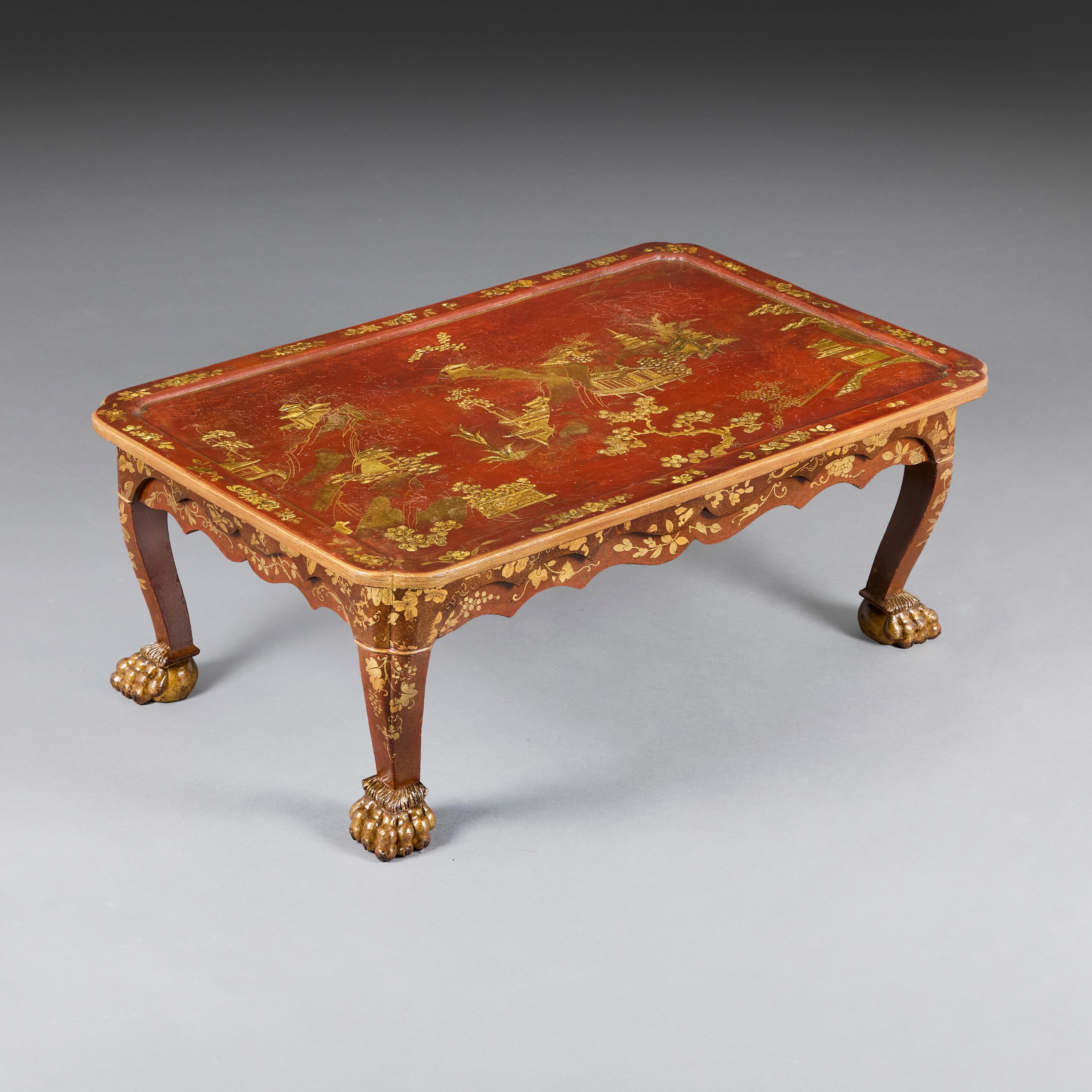 China, circa 1890.

A late nineteenth century Chinese rectangular red lacquer low table, the tray top hand-painted with gilded sceneries of provincial landscapes, the shaped apron with further naturalistic gilt decorations, all supported on four