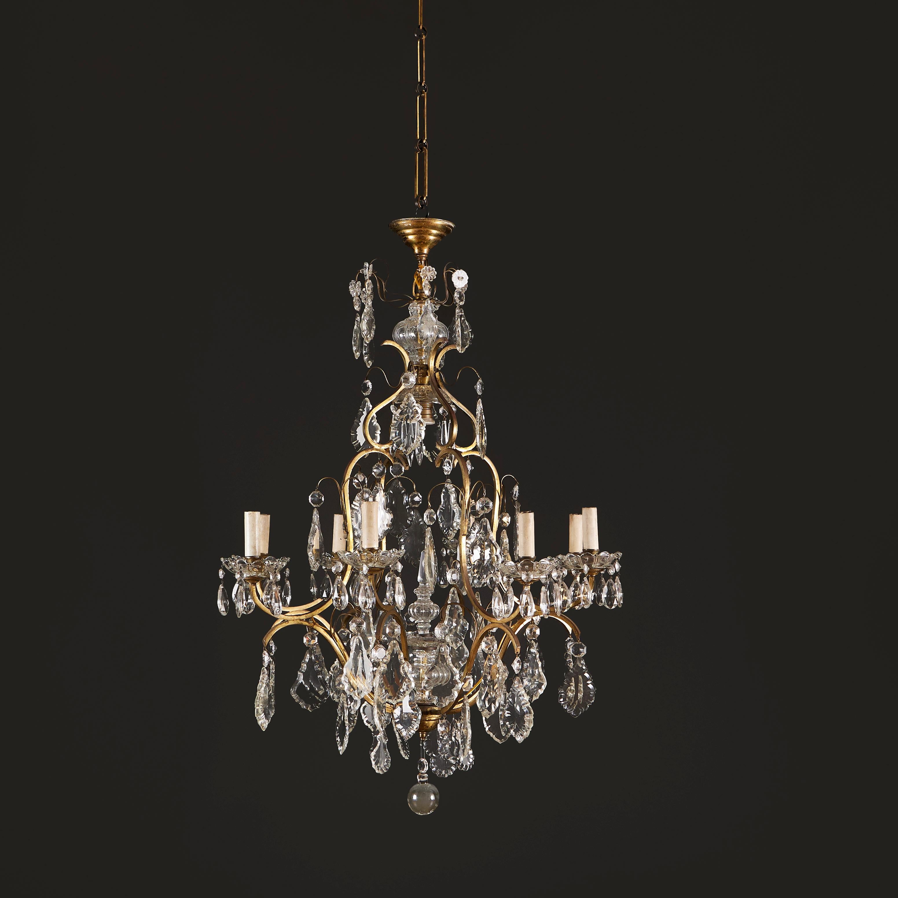 France, circa 1890

A late nineteenth century cut glass chandelier with eight candle arms, the brass scrolling frame adorned with cut glass droplets throughout, the upper level with glass paterae, all terminating in a spherical bauble to the