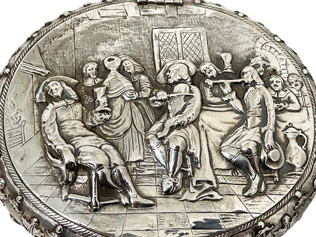 A 19th century Dutch silver tobacco box by J.J. Oosterbaan, Leeuwarden 1842

A beautifully decorated silver tobacco box with a Dutch scene from the Golden Age with a scene in an inn, after a painting by a Dutch 17th century master.
The box is