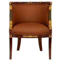 A 19th century Empire st. Mahogany, Giltwood, Ormolu and Leather armchair