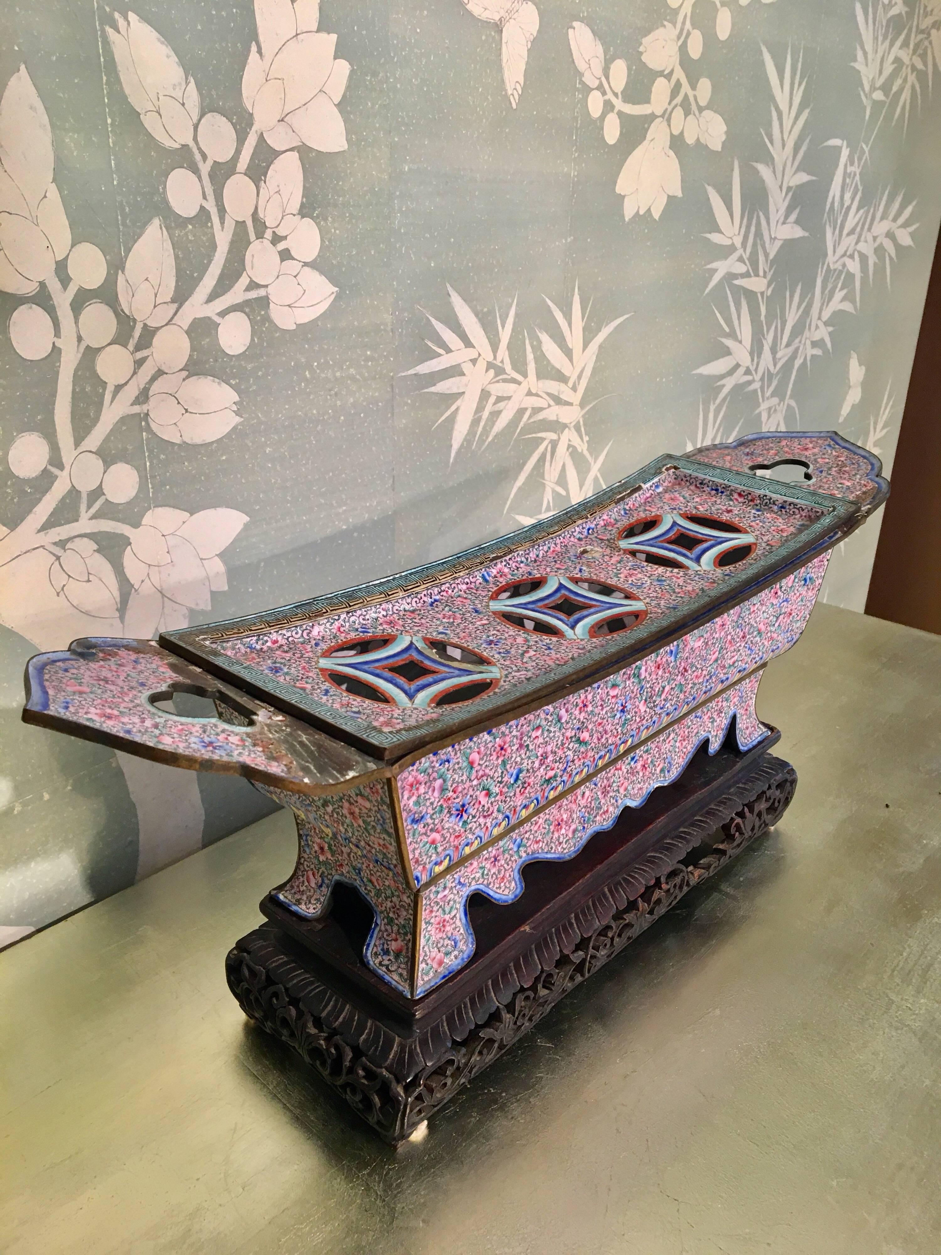 A 19th century Chinese pink enamel brazier. Intricately detailed with beautiful colors on a wooden stand. Measures: 9