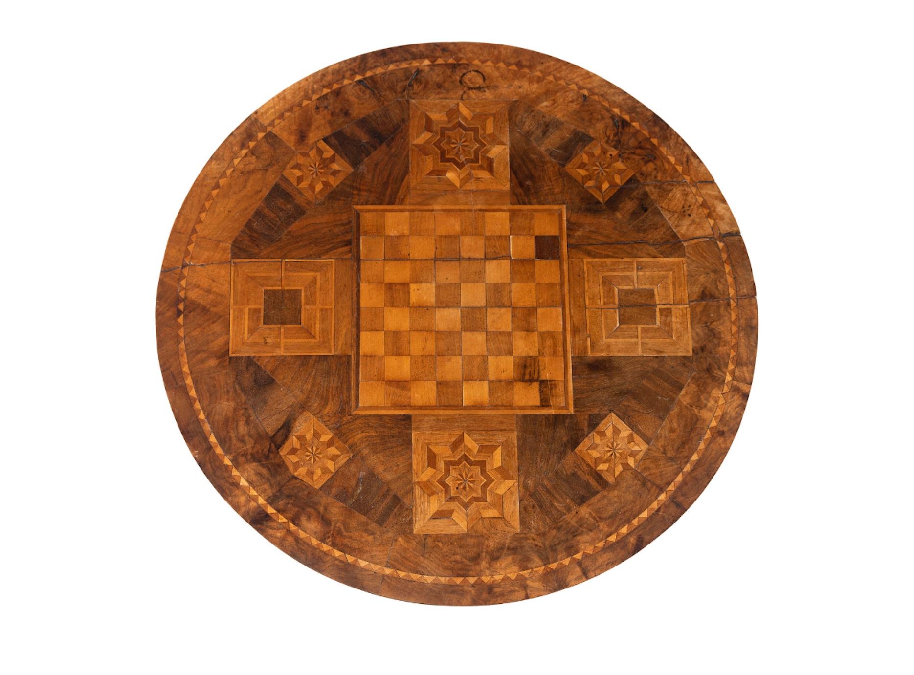 A Victorian Marquetry Game Table, Gaming Set and Treen Box
19th Century
Height 28 3/4 x diameter 24 1/4 inches.
Great color and patination.
Property from the Estate of Ruthann 