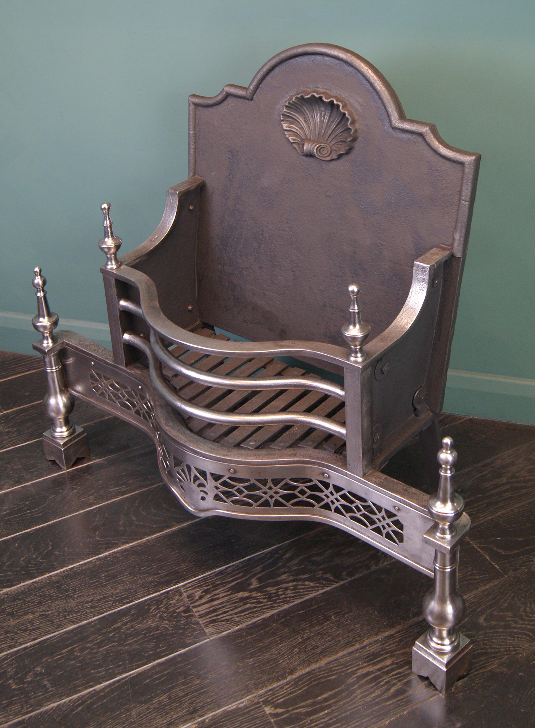 A fine 19th century English polished steel dog grate with centred circular front. A shaped deep openwork apron, with turned legs on plinths and urn finials uppermost. Restored. Central shell motif to shaped cast iron fire back. Restored.
Circa