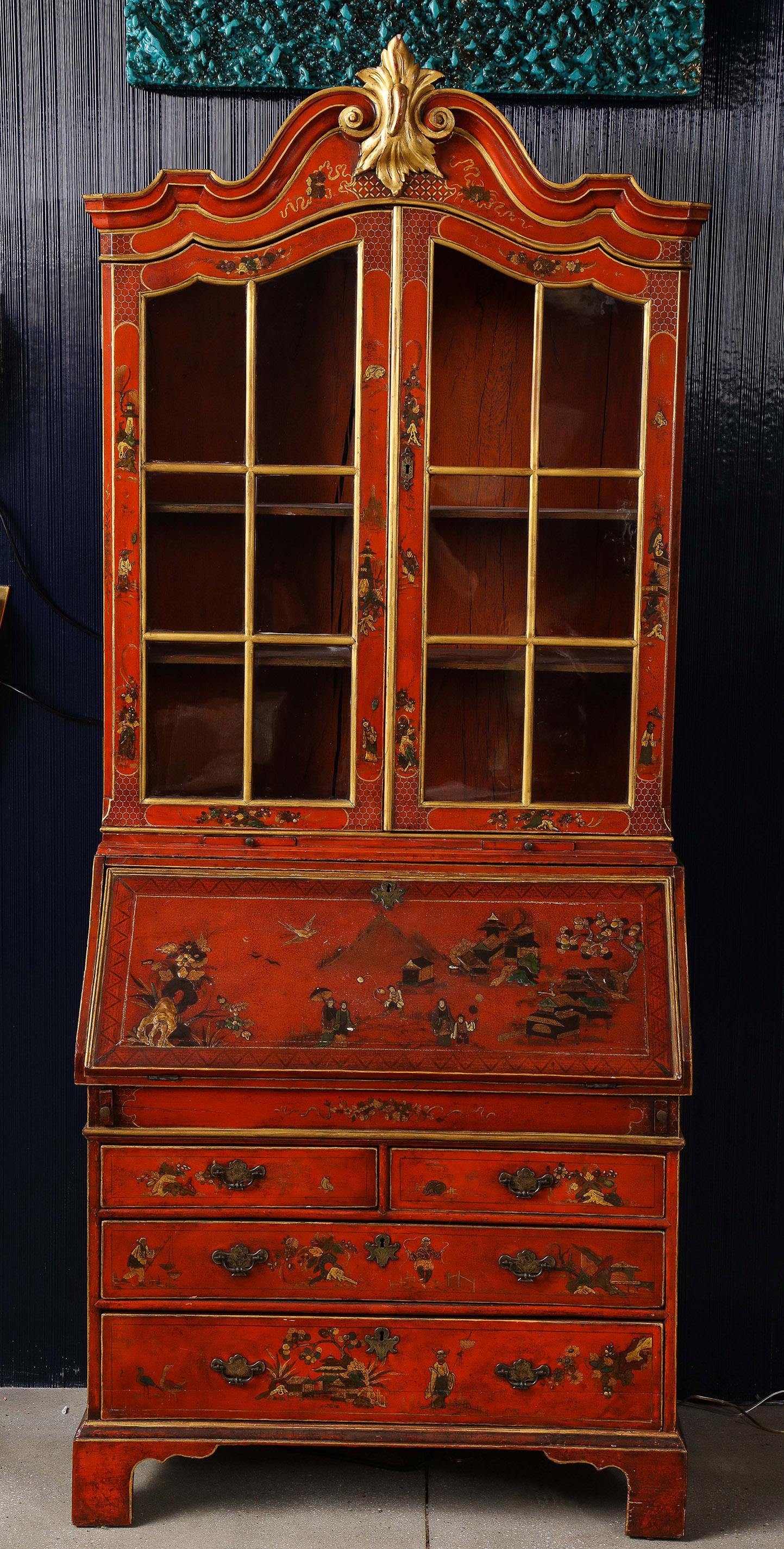 The whole having a lacquer decoration in the chinoiserie style with a top section of 2 glass paned doors and a shelved interior, over a fall front revealing a fitted interior, over 2 short and 2 long drawers all on bracket feet.