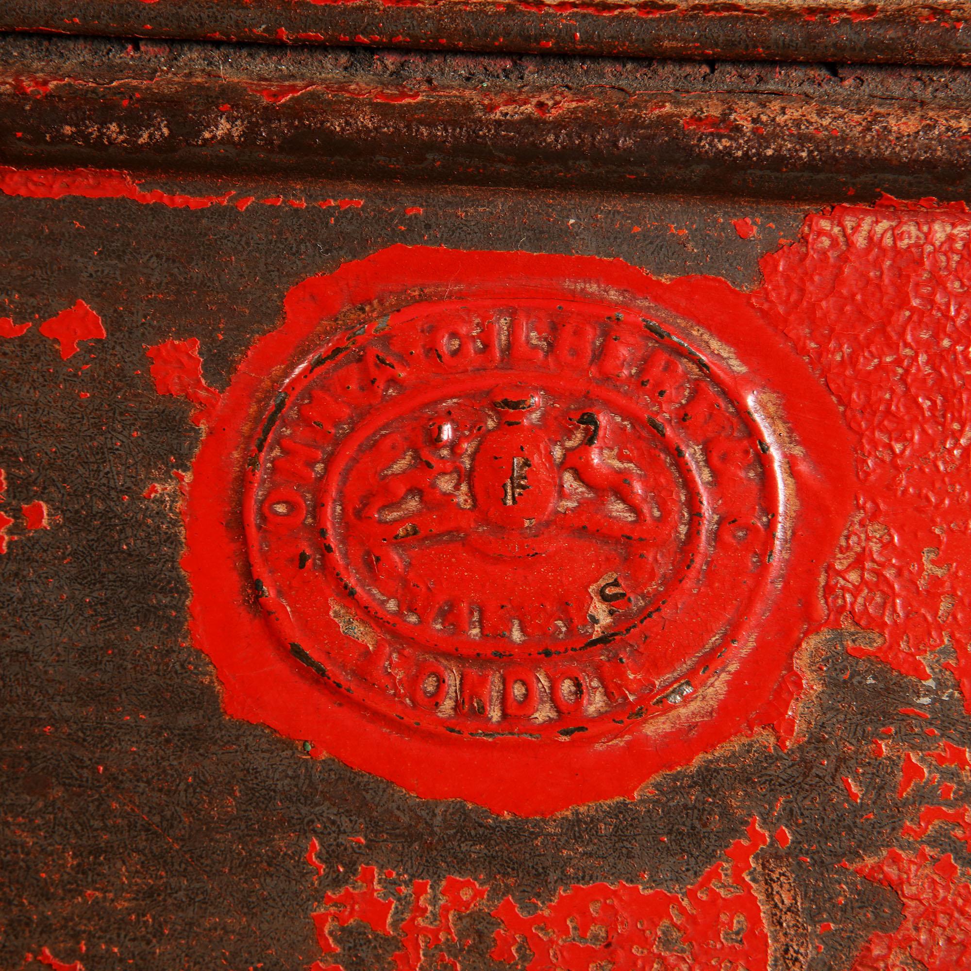 A mid-19th century red japanned tole chocolate tin from a shop display, with a hinged lid, the front with a gilt border decoration and inscribed ‘CHOCOLADE 2’, and stamped to the back with an oval makers mark inscribed ‘JOHN A. GILBERT & CO. MAKERS