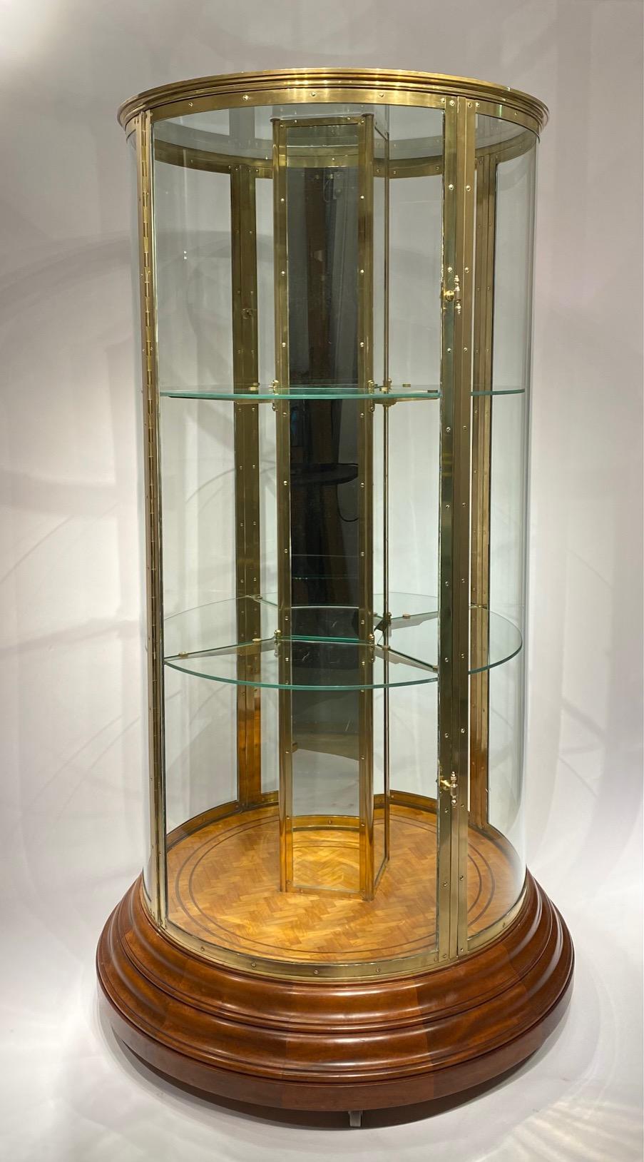 Brass An early 20th century English round freestanding  display cabinet.