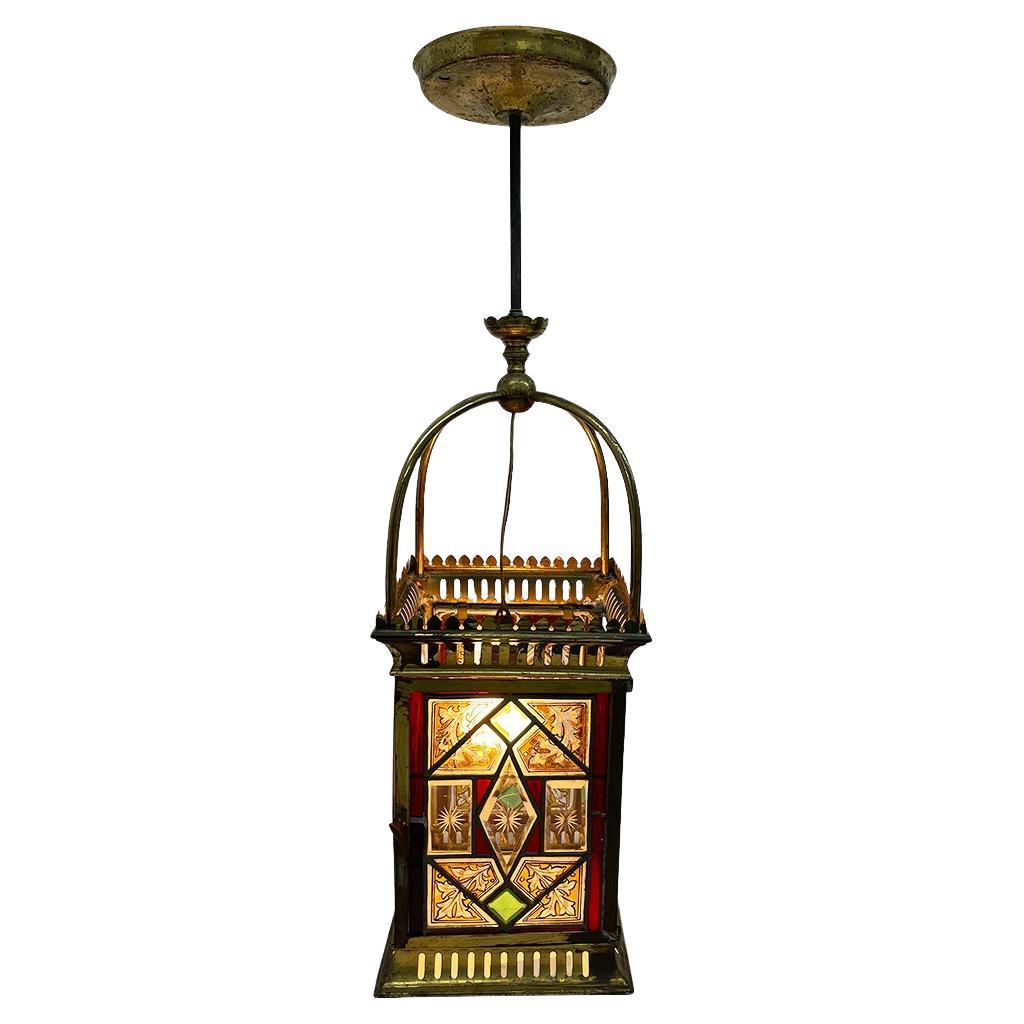 A 19th Century English stained glass Lantern

A lantern with stained glass panels, placed between clamps in a brass frame. The door with a turning knob can be opened. This was used because it was originally a candle lantern, but has been converted
