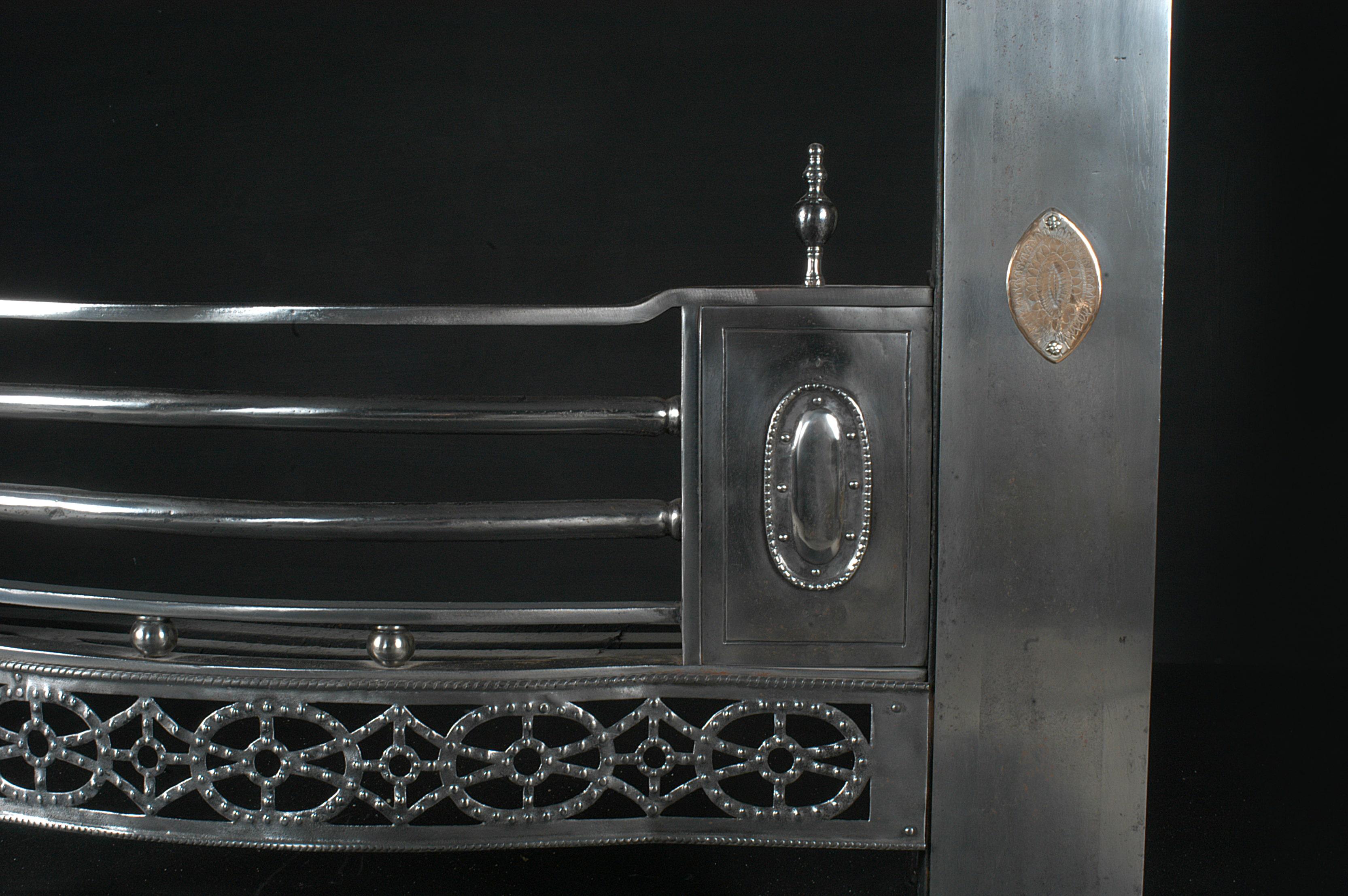 A Georgian style steel register grate with diamond and oval patterned fret, gun metal engraved centre and pateras and to frame. 19th century.

Width At Front:	1135 mm      	44 ⅝
