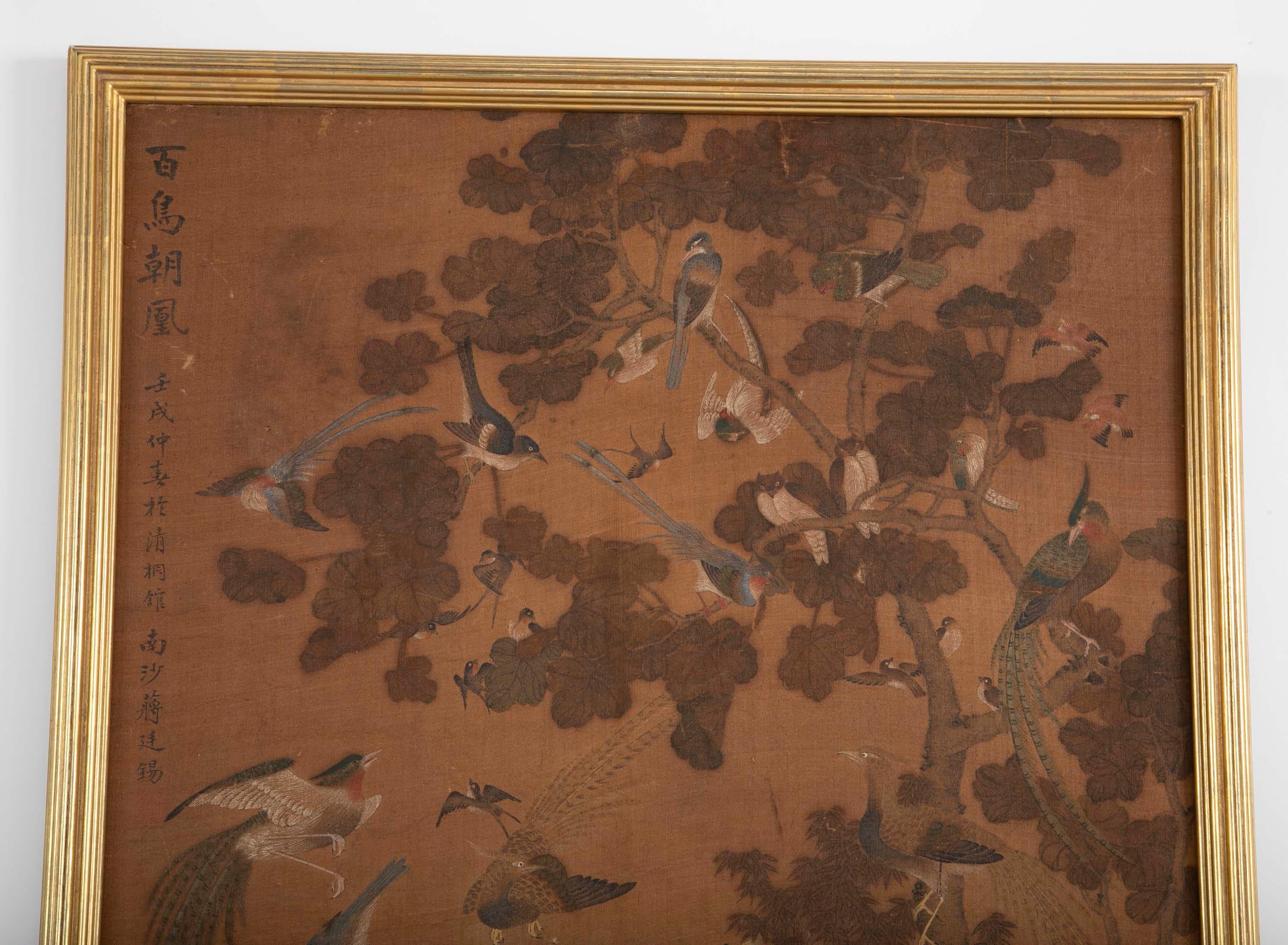 A 19th century framed Chinese scroll depicting the scene of a hundred birds. Laid down on silk backing. Framed in 22-karat yellow gold frame with acid free materials.