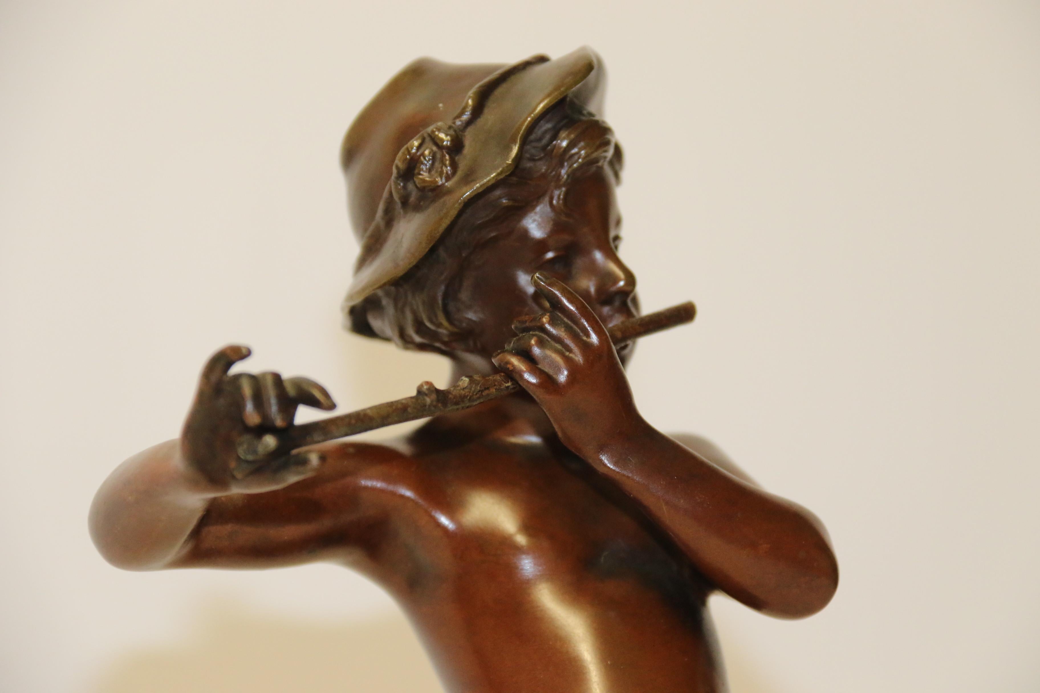 a sculpture with a putti standing beside him playing a flute