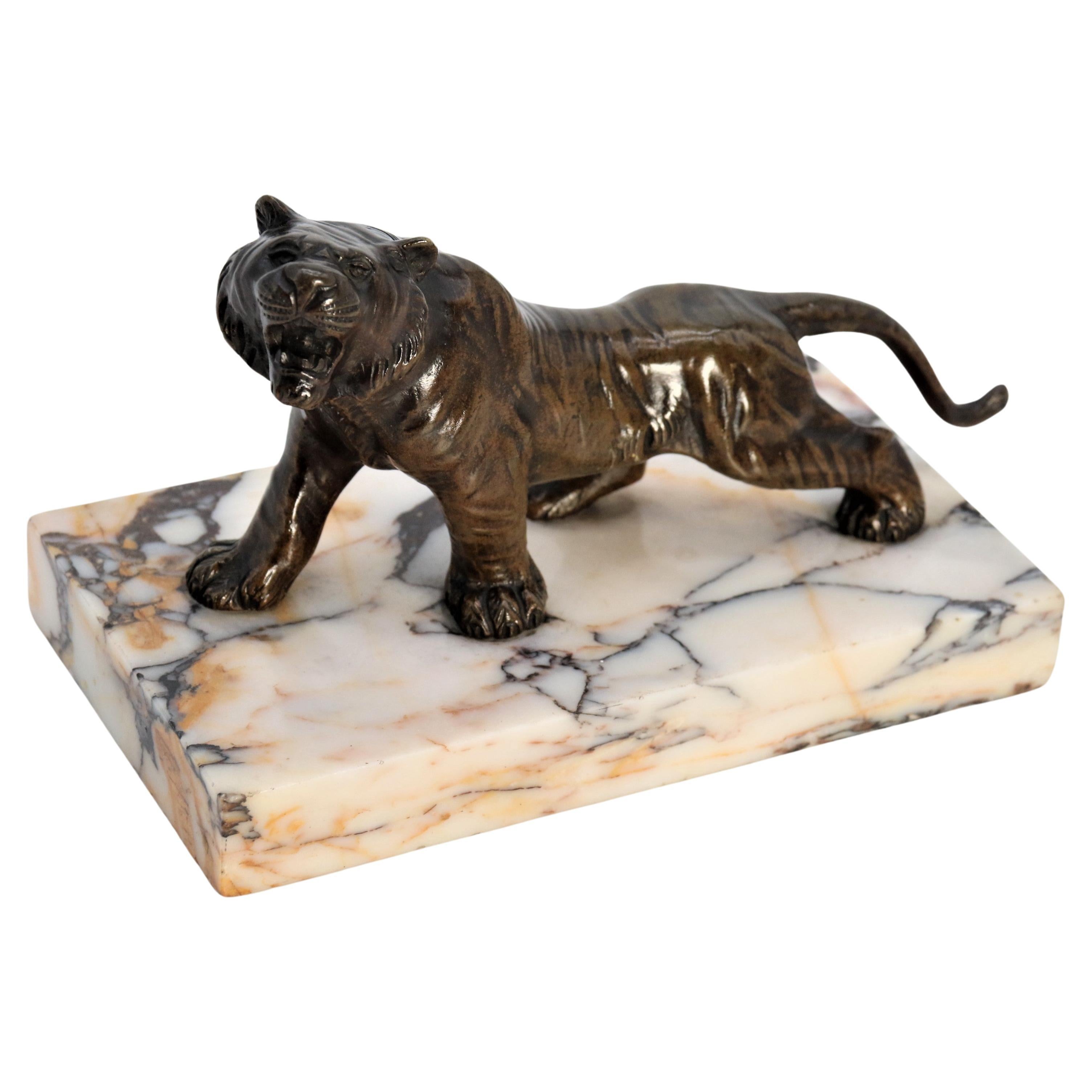 A  19th century French bronze study of a tiger on a marble base circa 1890