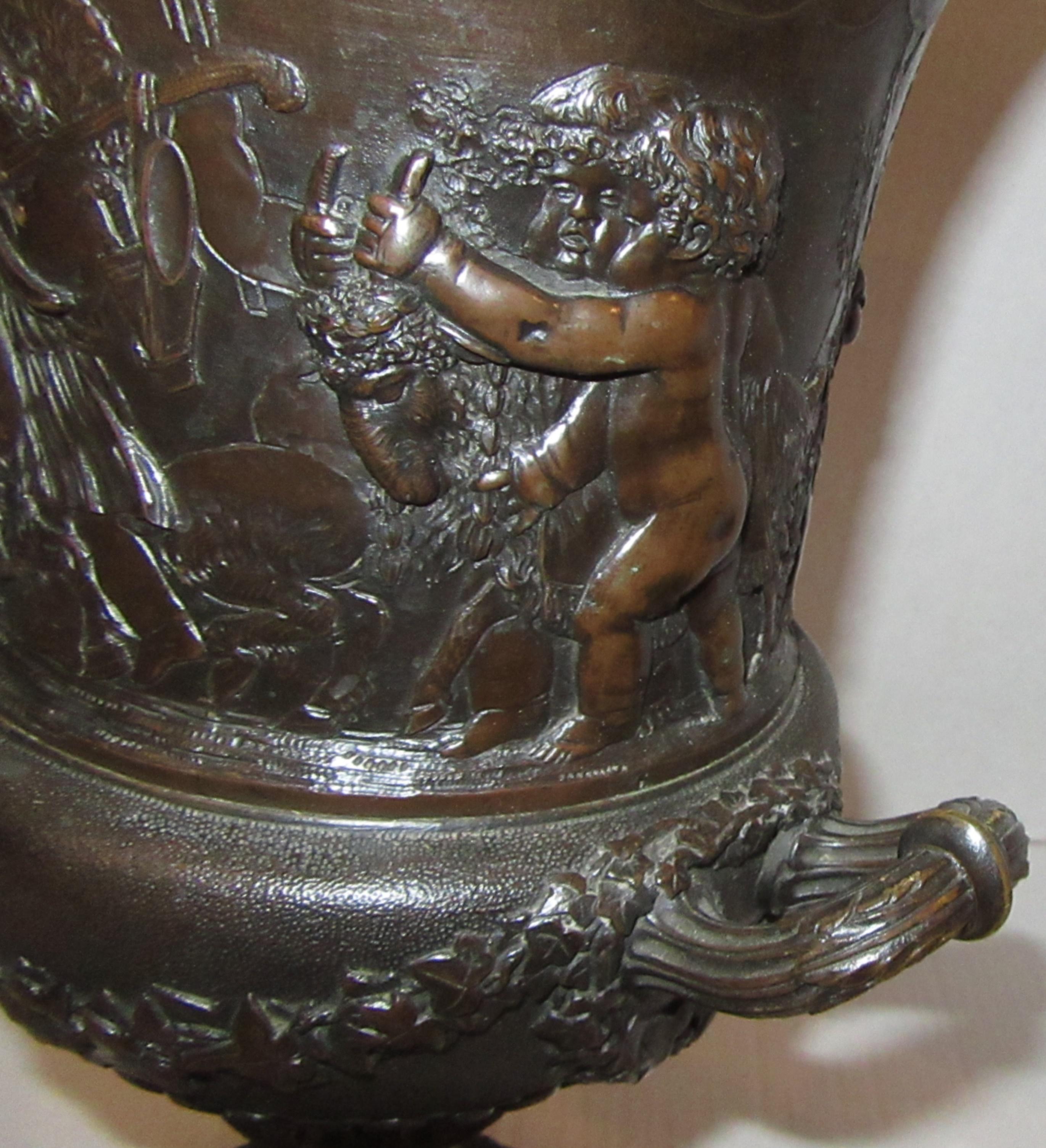 A campana form urn with twin handles, cast with frolicking putti and trailing ivy leaves. The basin seated on a spiral fluted foot over a square plinth. Stamped CLODION below one handle.
From the collection of Lord Vincent Constantine at Cross Hall