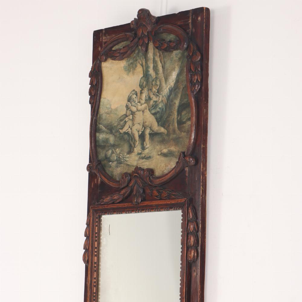 A 19th century French carved walnut narrow marble top wall mount console table with conforming trumeau mirror with Cherubs painted on canvas. This unit is very narrow and is a size that is very difficult to find. Both pieces are in very good
