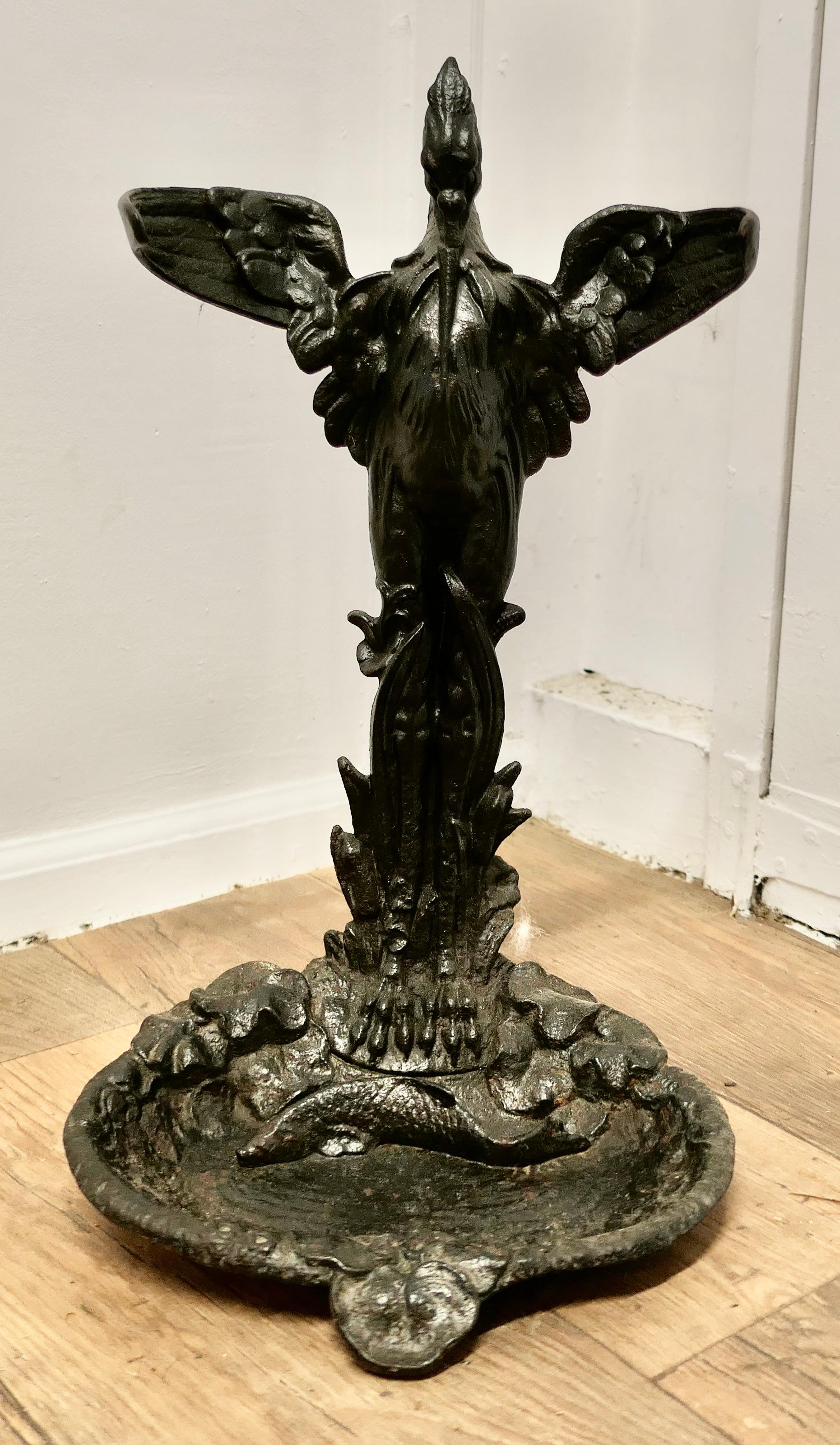 A 19th Century French Cast Iron Umbrella Stand.

19th Century French Cast Iron Umbrella Stand this is a beautifully detailed piece  showing a stork standing over the water watching a fish in the pond below. 
The bird’s outstretched wings curve to