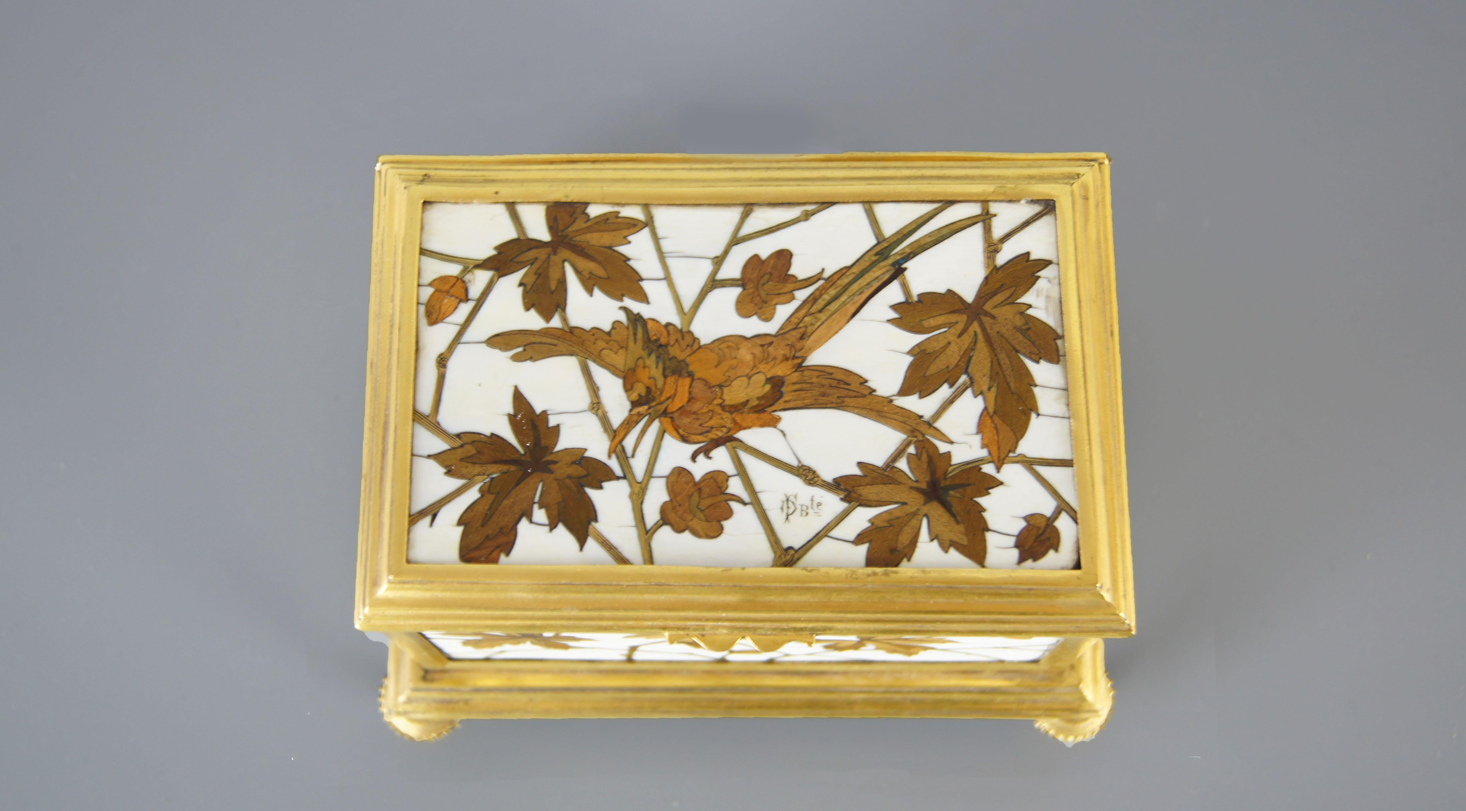 A French gilt-bronze mounted, fruit wood and ivory marquetry metal cloisonné jewellery box by Maison Alphonse Giroux and Ferdinand Duvinage, Paris, circa 1875, rectangular, on four feet, the lid with a bird on a foliate branch, signed.