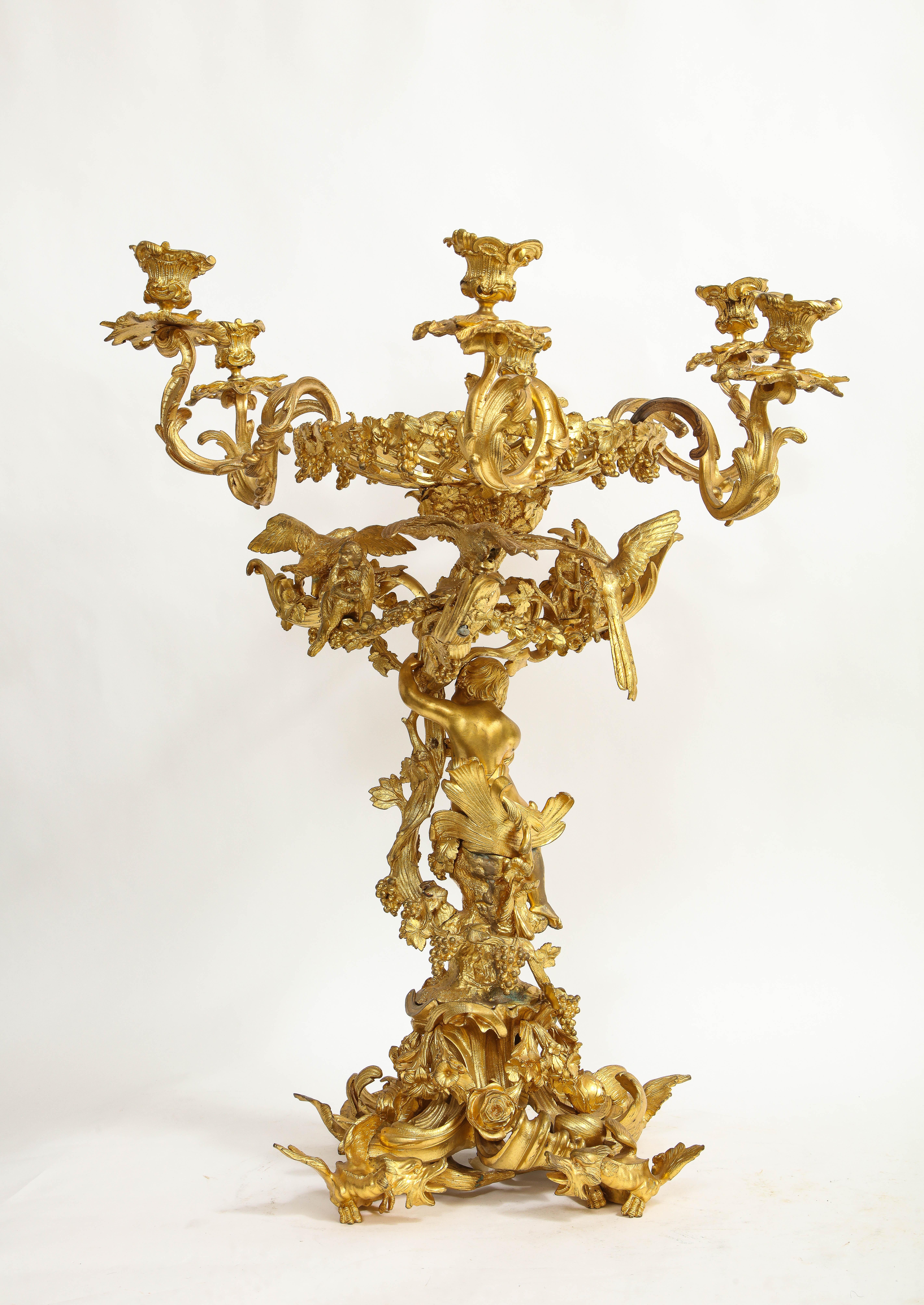 A Fantastic 19th century French Louis XV style Dore bronze figural centerpiece/ six arm candelabra. Truly a marvelous piece that is beautifully cast, hand-chased, and hand-chiseled. The base is beautifully decorated with a fantastic dore bronze
