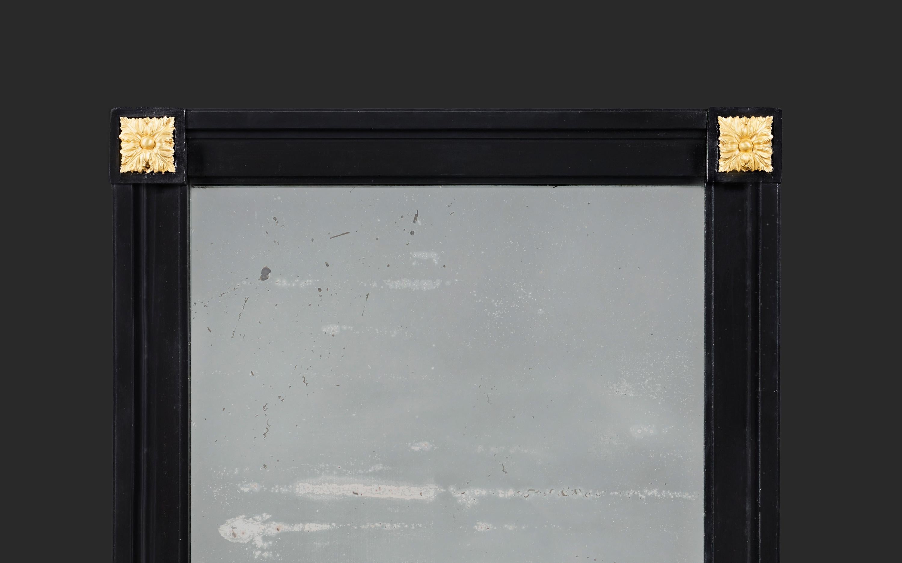 France, circa 1840

A mid-nineteenth century French ebonised rectangular mirror, the corners with ormolu paterae, retaining its original oxidised mirror plate.

Height 66.50cm
Width 55.00cm