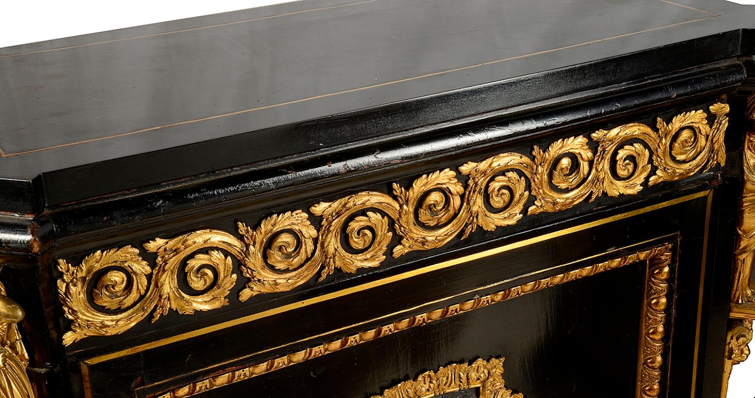 A very good quality 19th century ebonised pier / side cabinet,  with gilded scrolling foliate ormolu mounts to the frieze, classical monopodia supports, a single door with inset classical panels, egg and dart mouldings and raised on a plinth base.