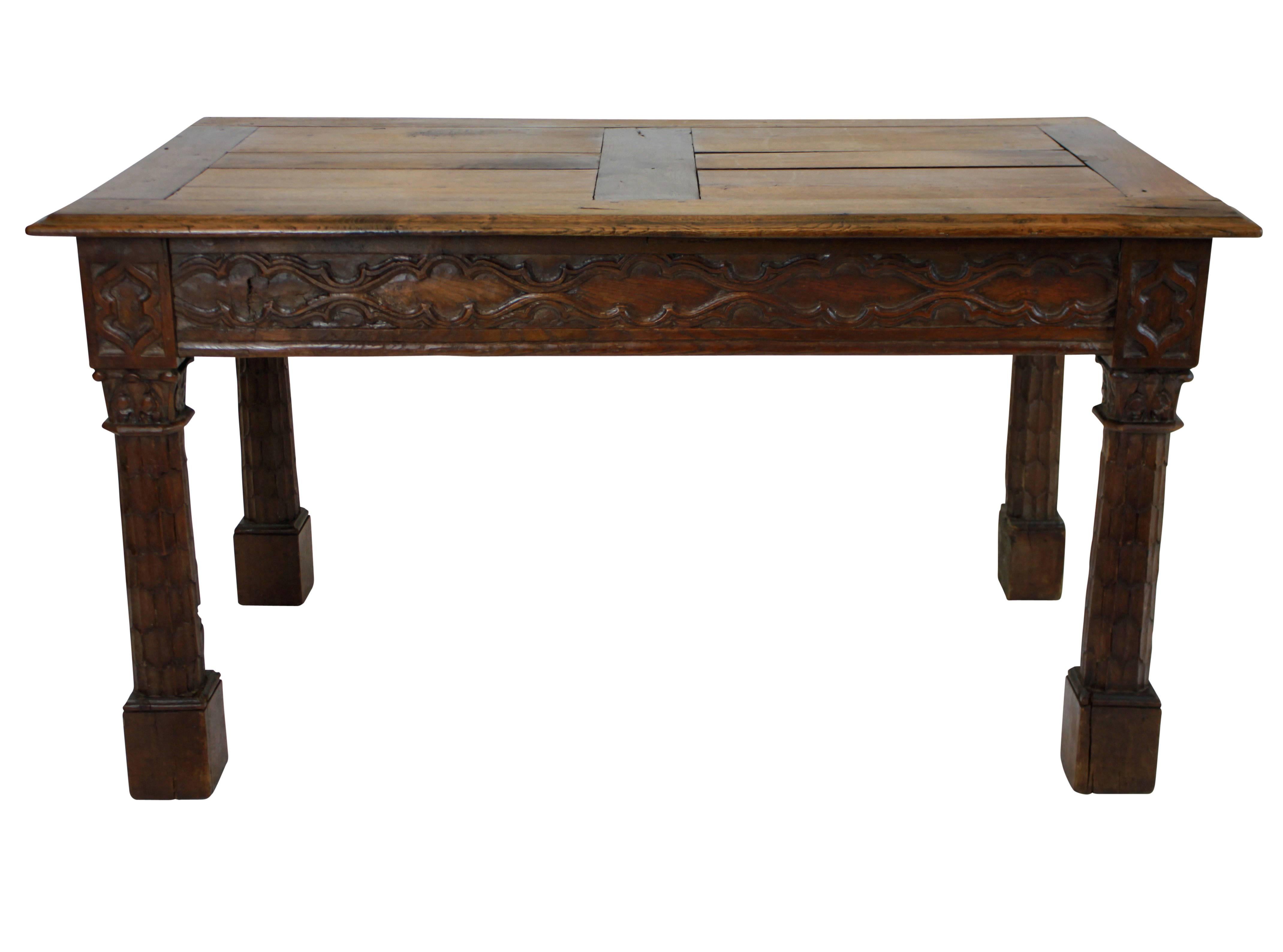 A French Gothic Revival oak center table of good quality with tracery friezes on all four sides and palm tree inspired legs.
 