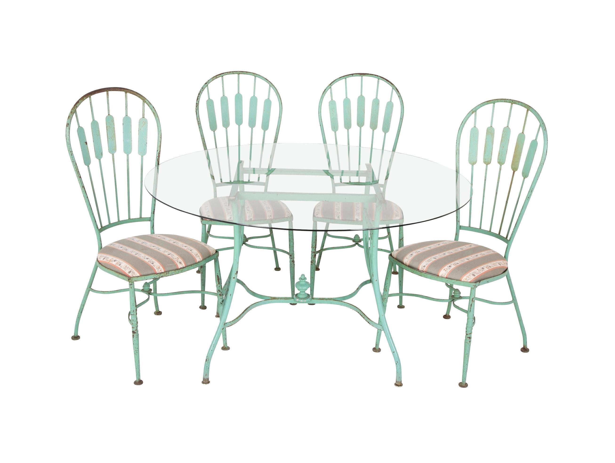 A 19th century French iron glass top dining table with four matching chairs. From Isleboro, Maine estate of a noted collector. Table dimensions: 27.75