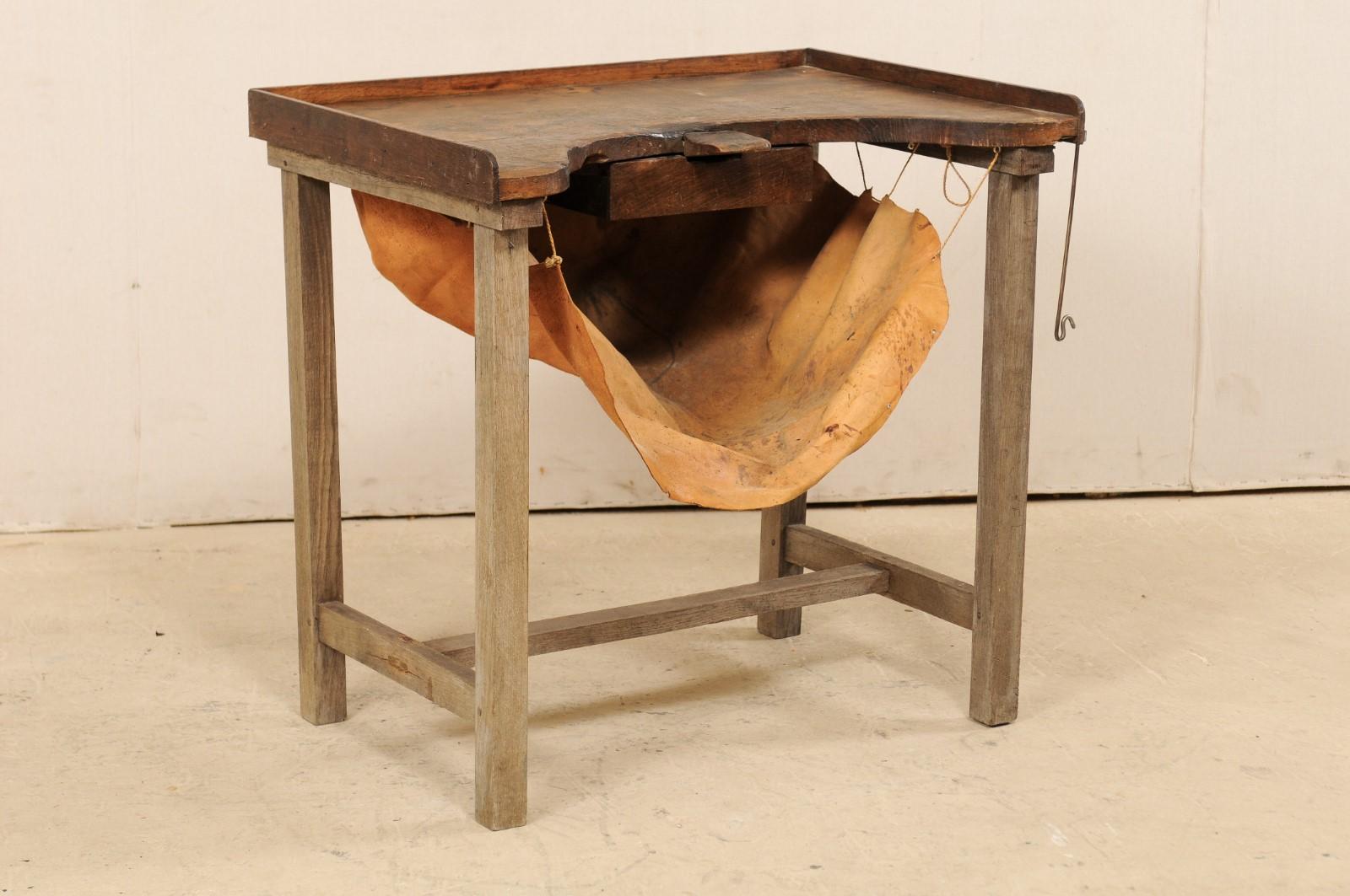 A French jeweler's work bench table from the early 19th century. This unusual French table was originally used during the early 19th century by a jewelry maker, as a work bench for designing. The table features a mostly rectangular-shaped top with