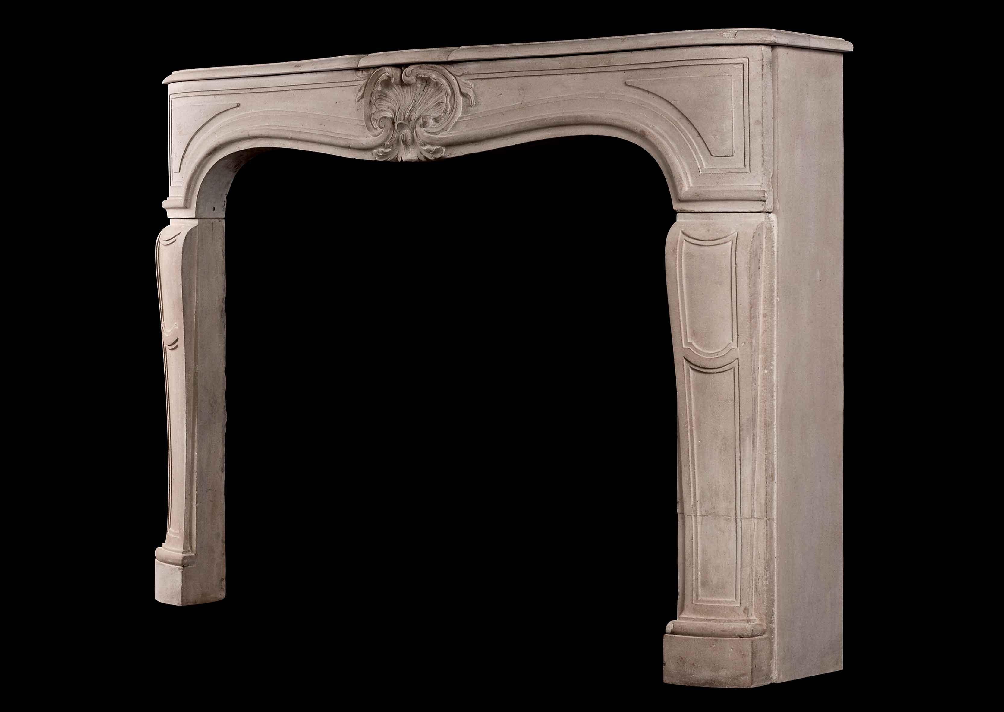 A 19th century French Louis XV style limestone fireplace. The panelled jambs surmounted by sweeping frieze featuring carved shell and foliage. Shaped shelf.

Shelf Width: 1440 mm 56 ¾
