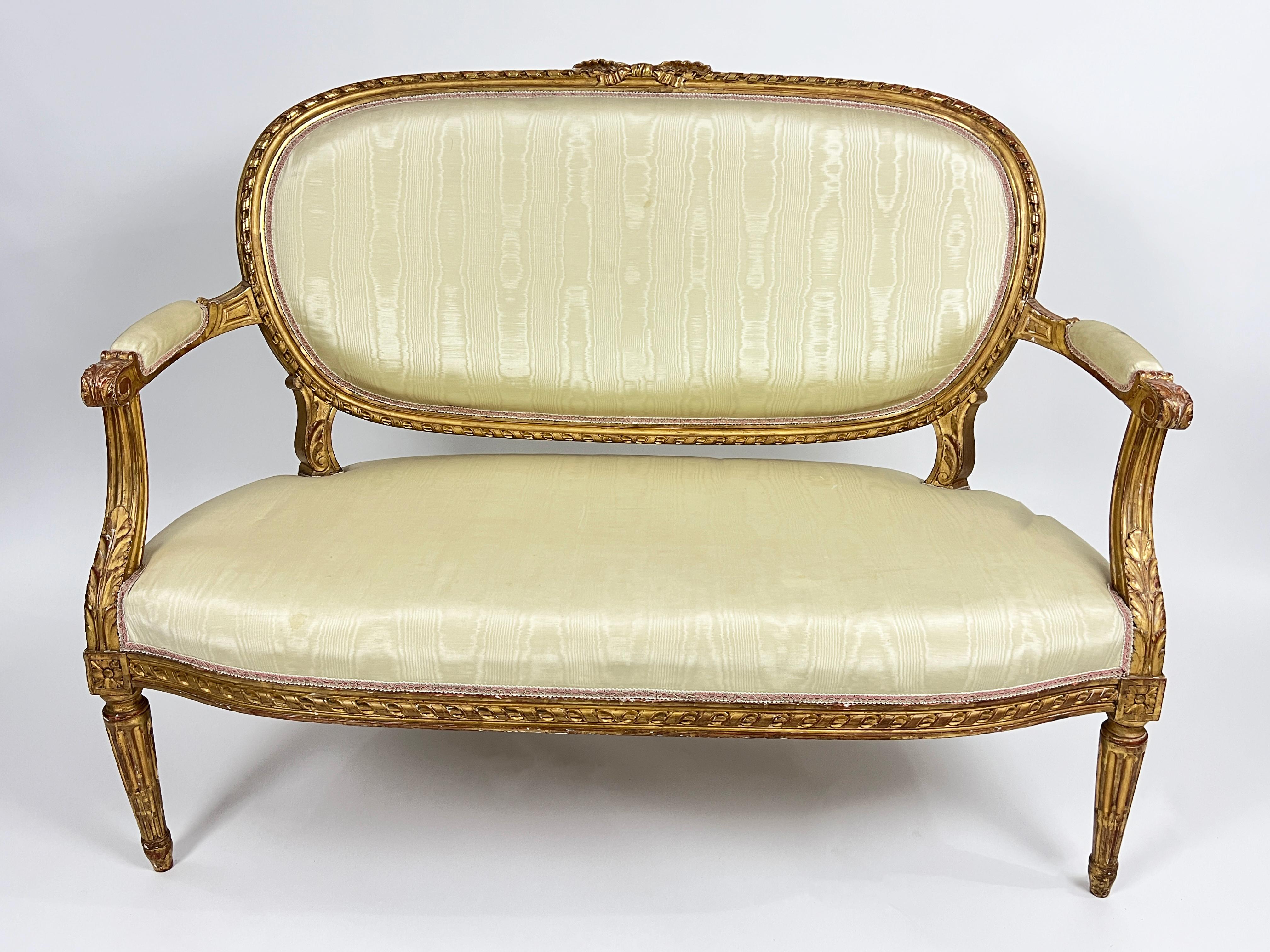 A fine 19th century salon suite comprising a canapé / sofa and four fauteuils / open armchairs, each with a rope-twist carved frame, oval padded back, arms and seat covered in white silky upholstery, on stop-fluted tapering legs. 

Dimensions: