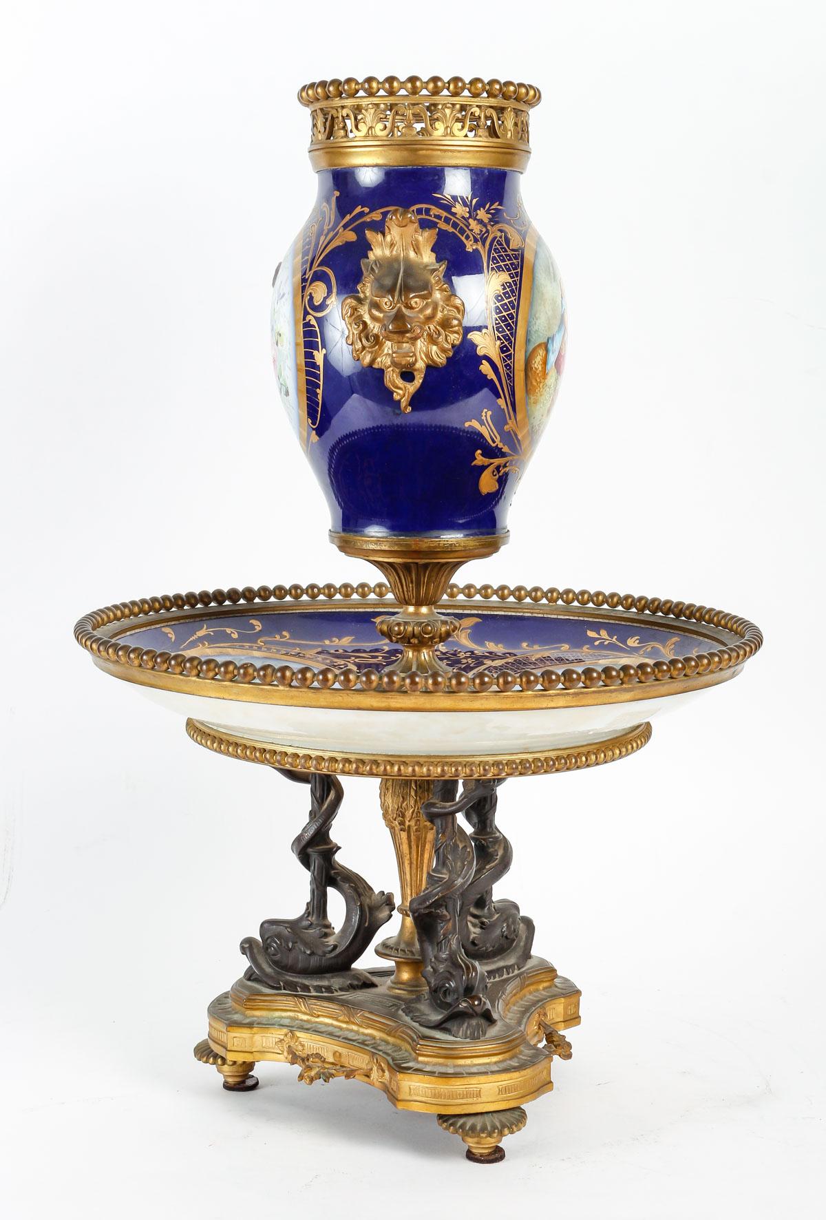 A 19th Century French  Napoléon III Surtout de Table

French 19th Century Hand-Painted Porcelain and Ormolu-Mounted Surtout De Table
Composed of two parts, a tray forming display in the lower part, a vase in the upper part, fixed and mounted in the